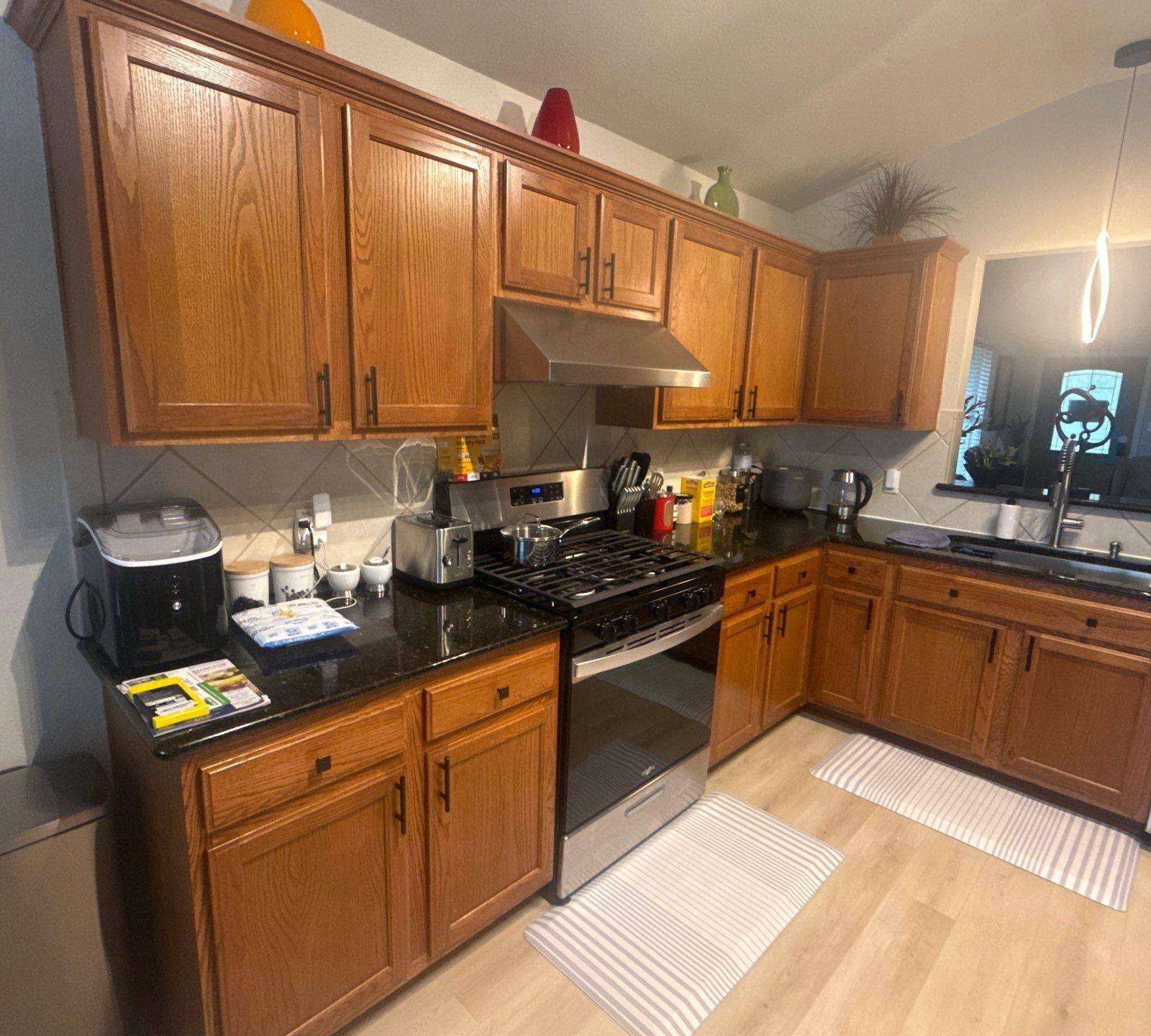 Kitchen cabinets of a home in Austin, TX ahead of cabinet refinishing by Hill Country Painting