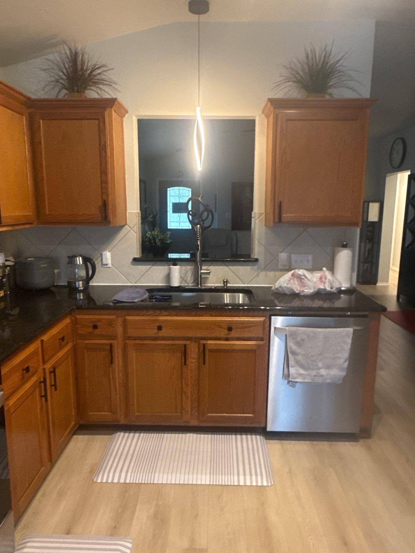 Kitchen cabinetry and layout of a home in Austin, TX ahead of cabinet refinishing by Hill Country Painting
