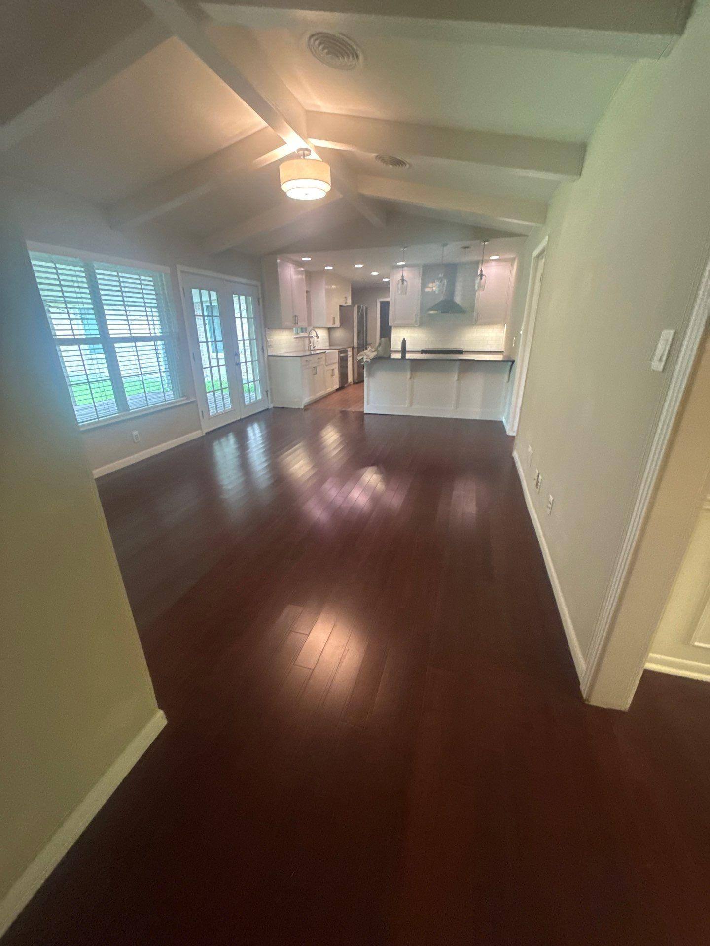 Open-concept living area with vaulted beamed ceiling in a home in Austin, TX ahead of interior painting by Hill Country Painting