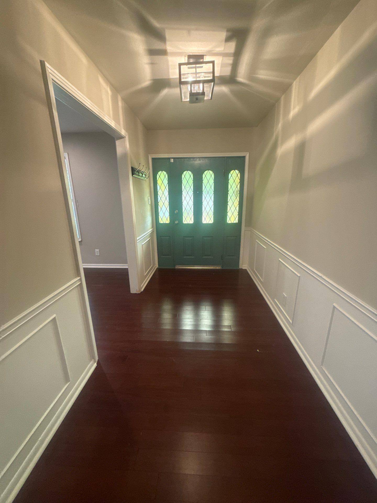 Entryway with stained glass front door in a home in Austin, TX ahead of interior painting by Hill Country Painting