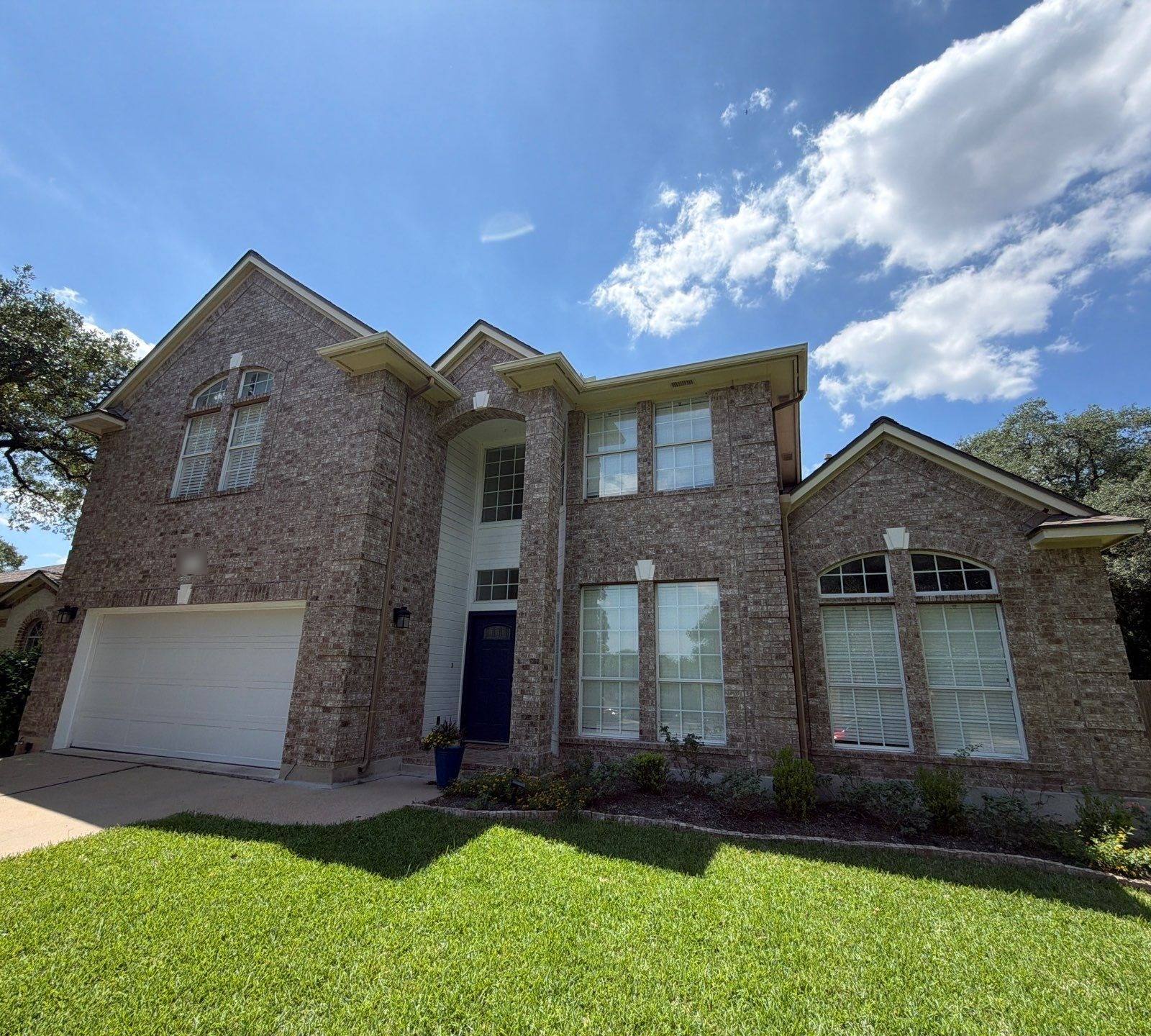 Two-story brick home on Bending Oak Rd in Austin, TX ahead of exterior painting by Hill Country Painting