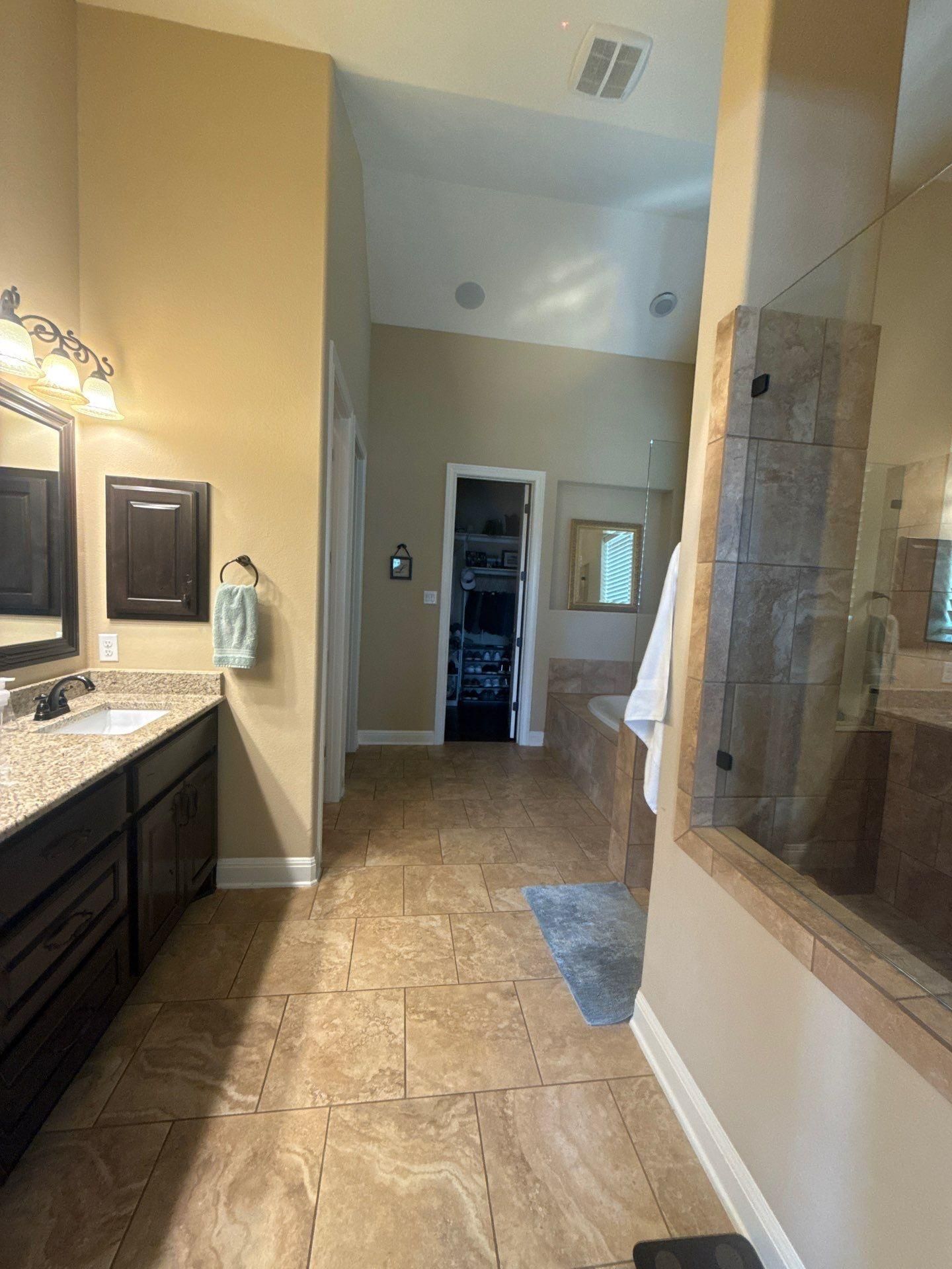 Master bathroom with dual vanity and walk-in shower in a home in Austin, TX ahead of interior painting by Hill Country Painting