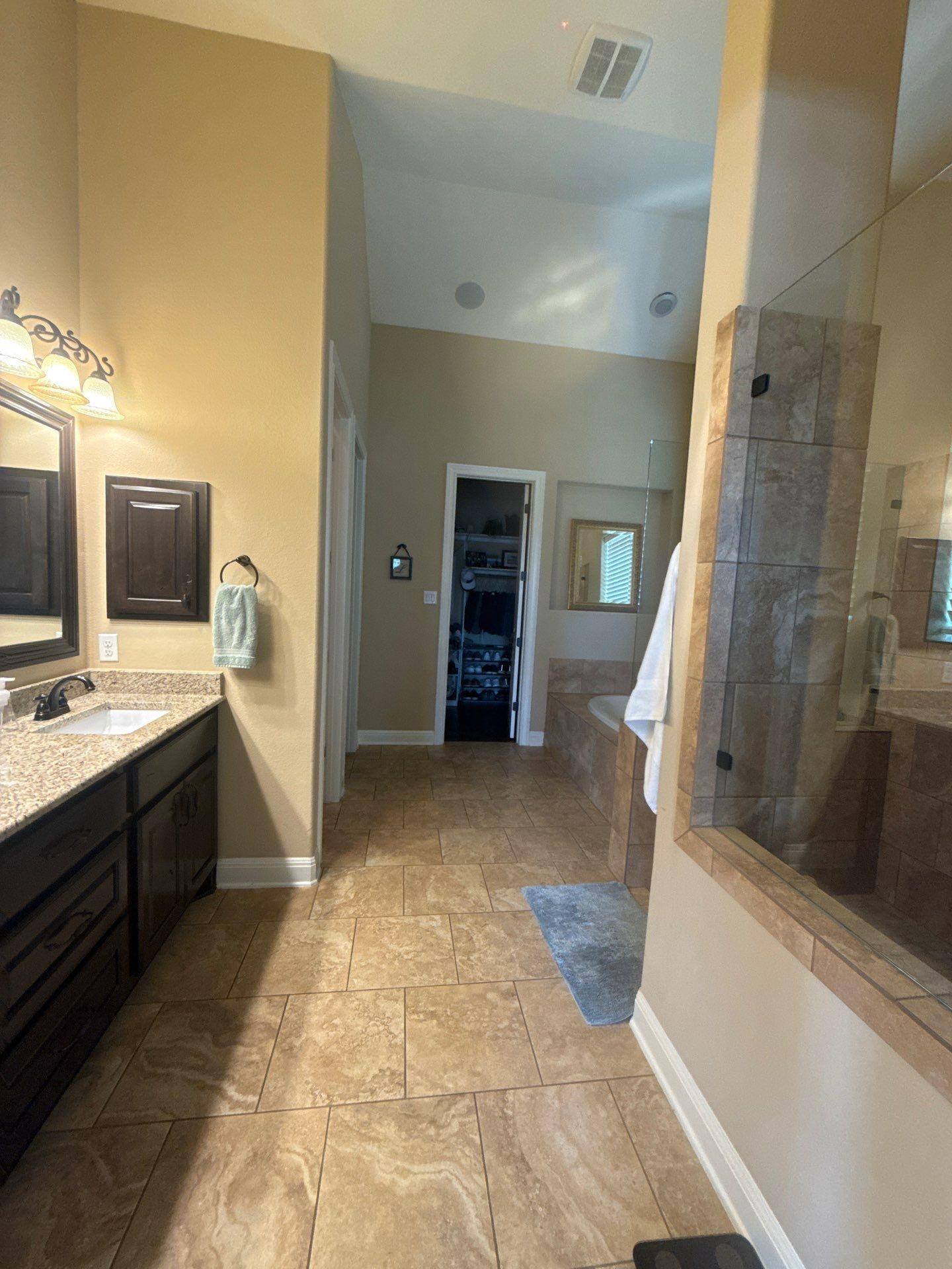 Master bathroom with dual vanity and walk-in shower in a home in Austin, TX ahead of interior painting by Hill Country Painting