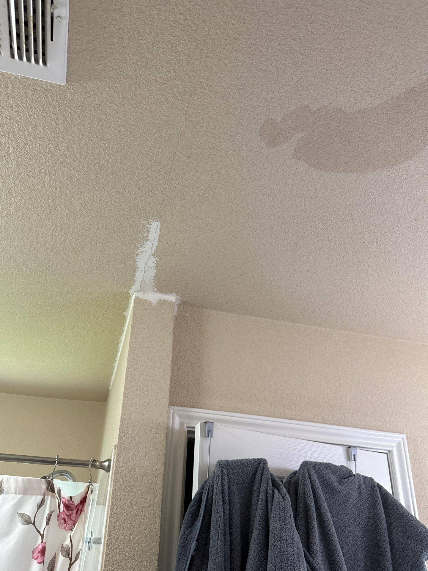 Bathroom ceiling area with drywall repair noted in a home on Delby St in Hutto, TX ahead of interior painting by Hill Country Painting