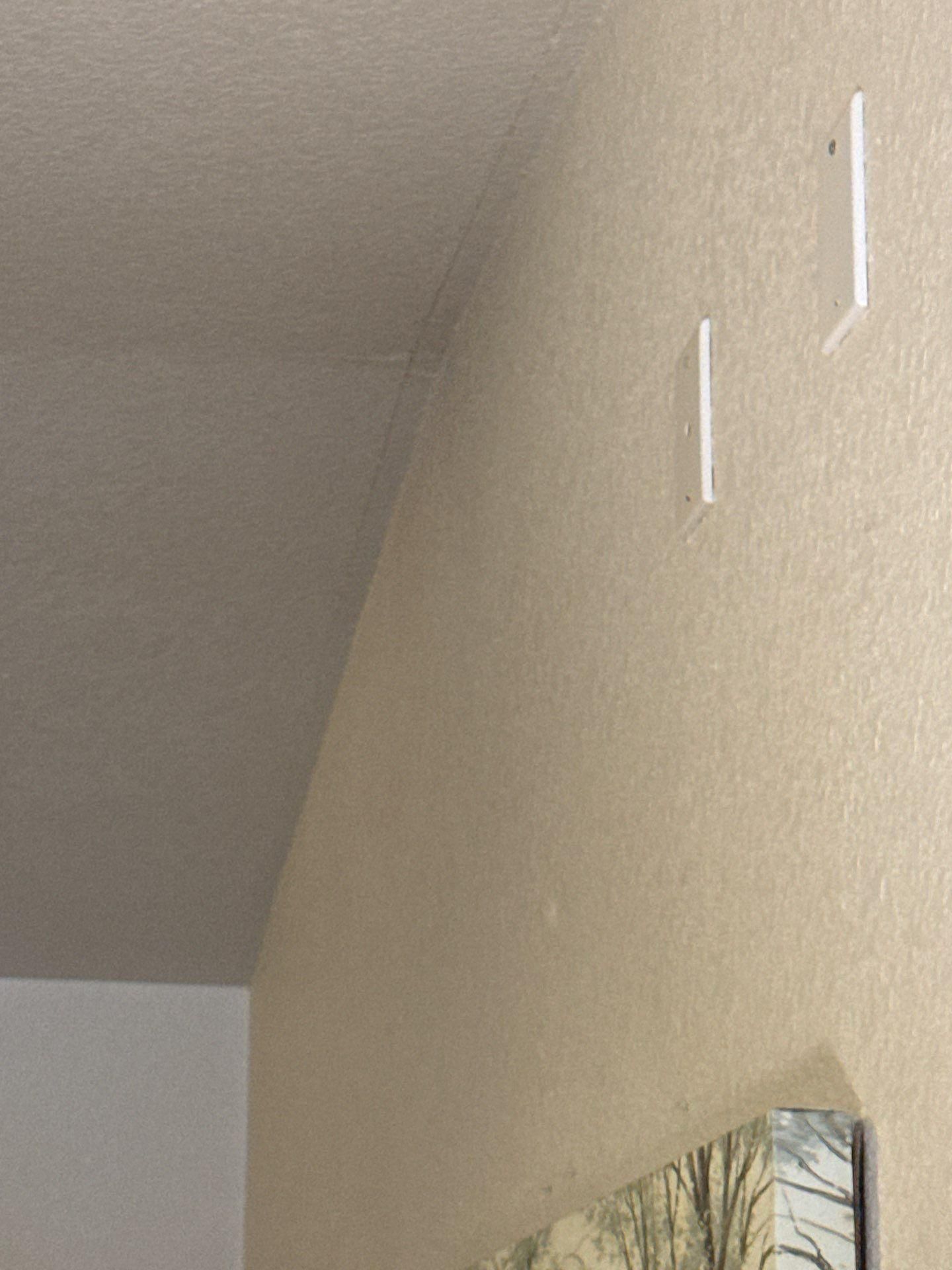 Ceiling and wall corner with a hairline crack ahead of interior painting and drywall repair by Hill Country Painting in Round Rock, TX