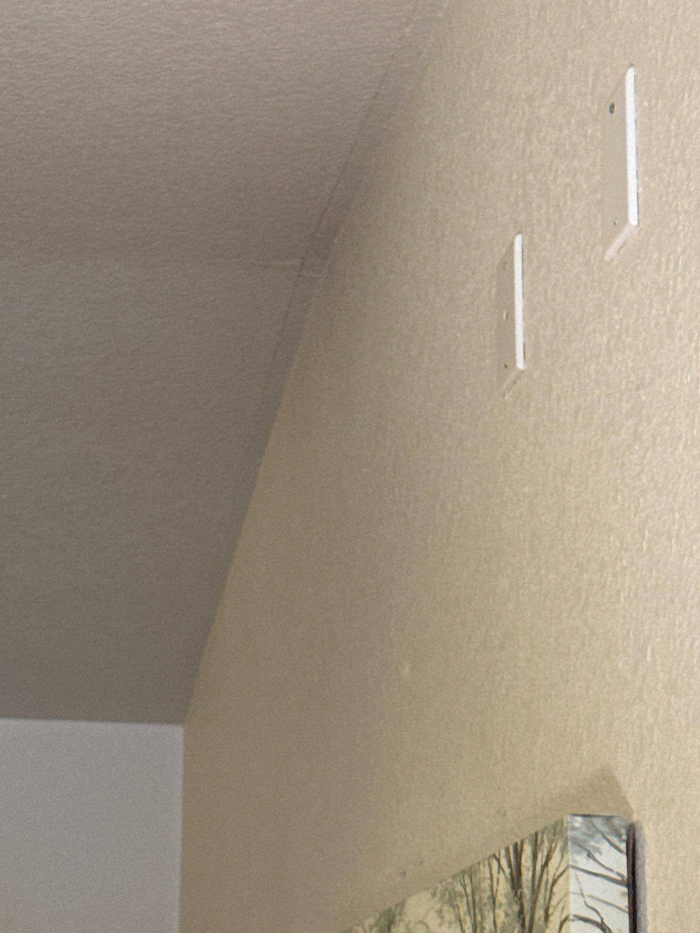 Ceiling and wall corner with a hairline crack ahead of interior painting and drywall repair by Hill Country Painting in Round Rock, TX