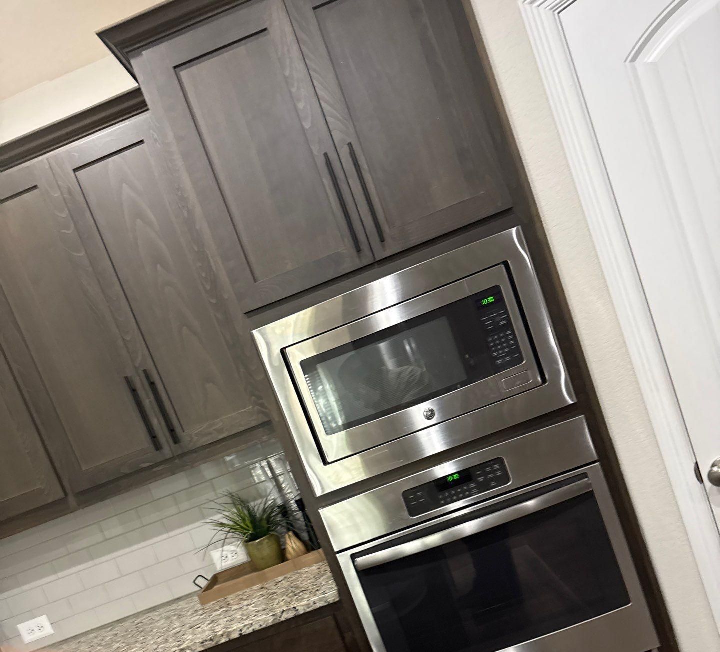 Kitchen cabinets and ceiling in a townhome on Westinghouse in Round Rock, TX ahead of interior painting by Hill Country Painting