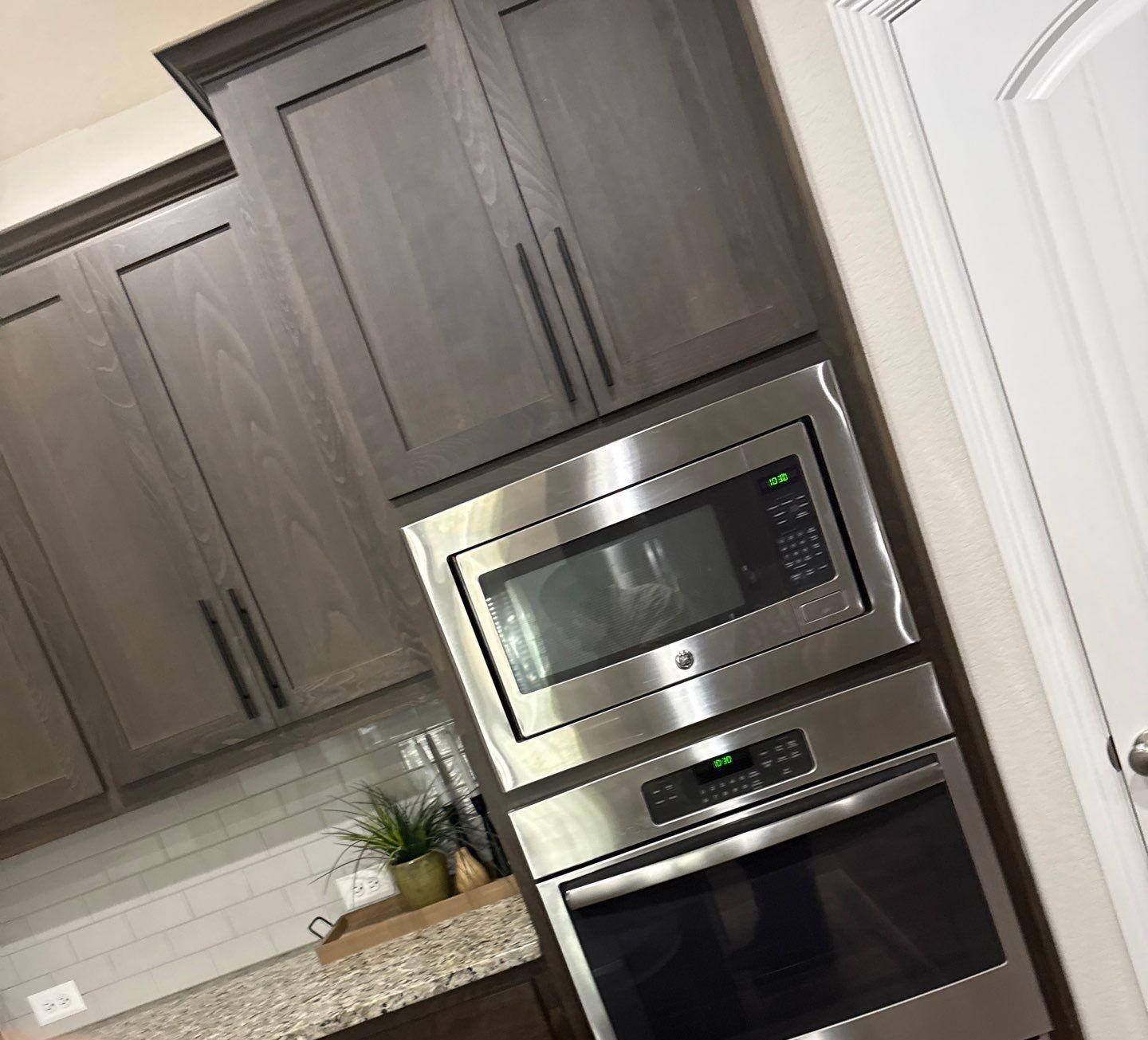 Kitchen cabinets and ceiling in a townhome on Westinghouse in Round Rock, TX ahead of interior painting by Hill Country Painting