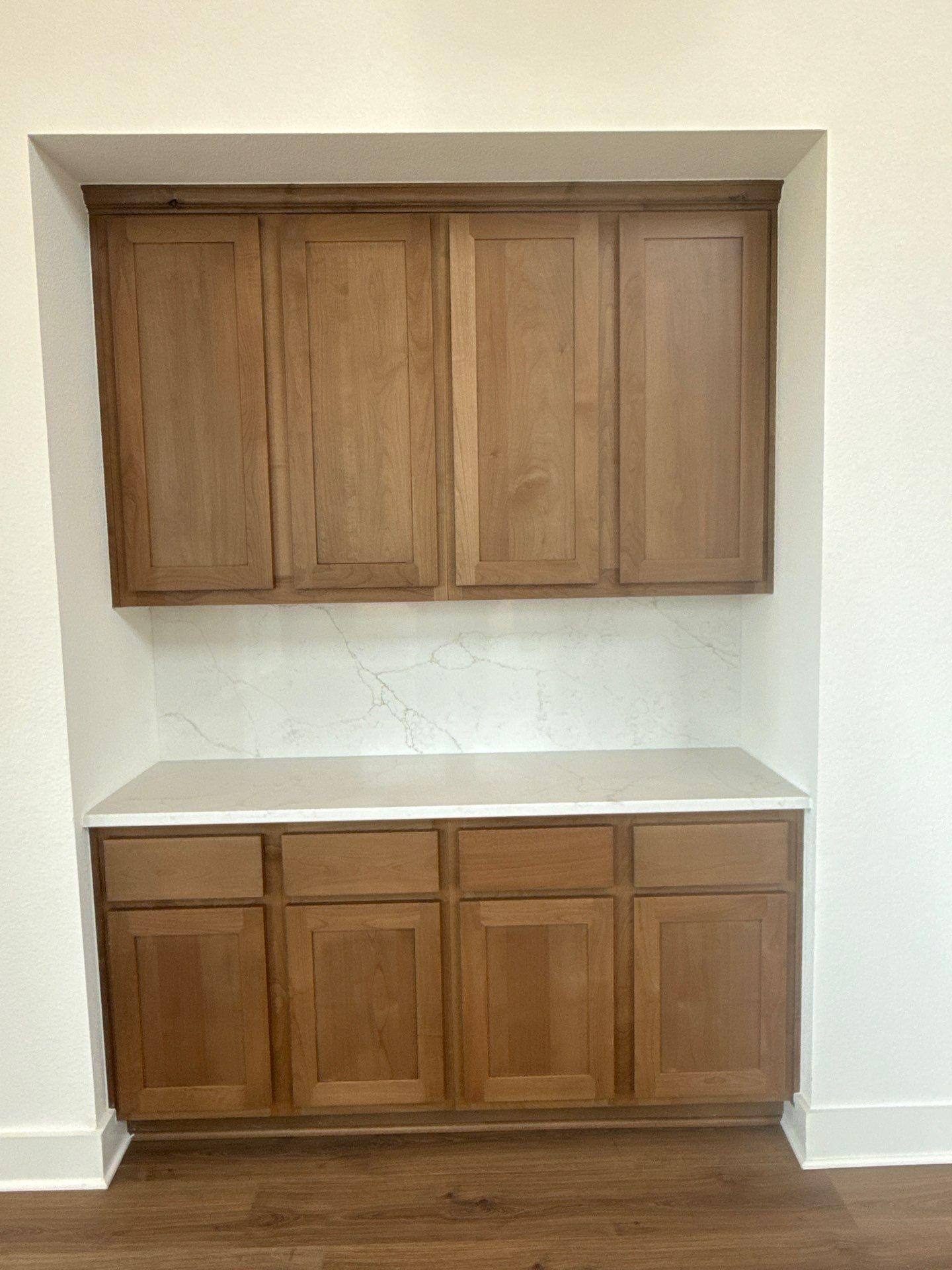 Built-in kitchen cabinets in a home on Covered Bridge Trl in Georgetown, TX refinished by Hill Country Painting