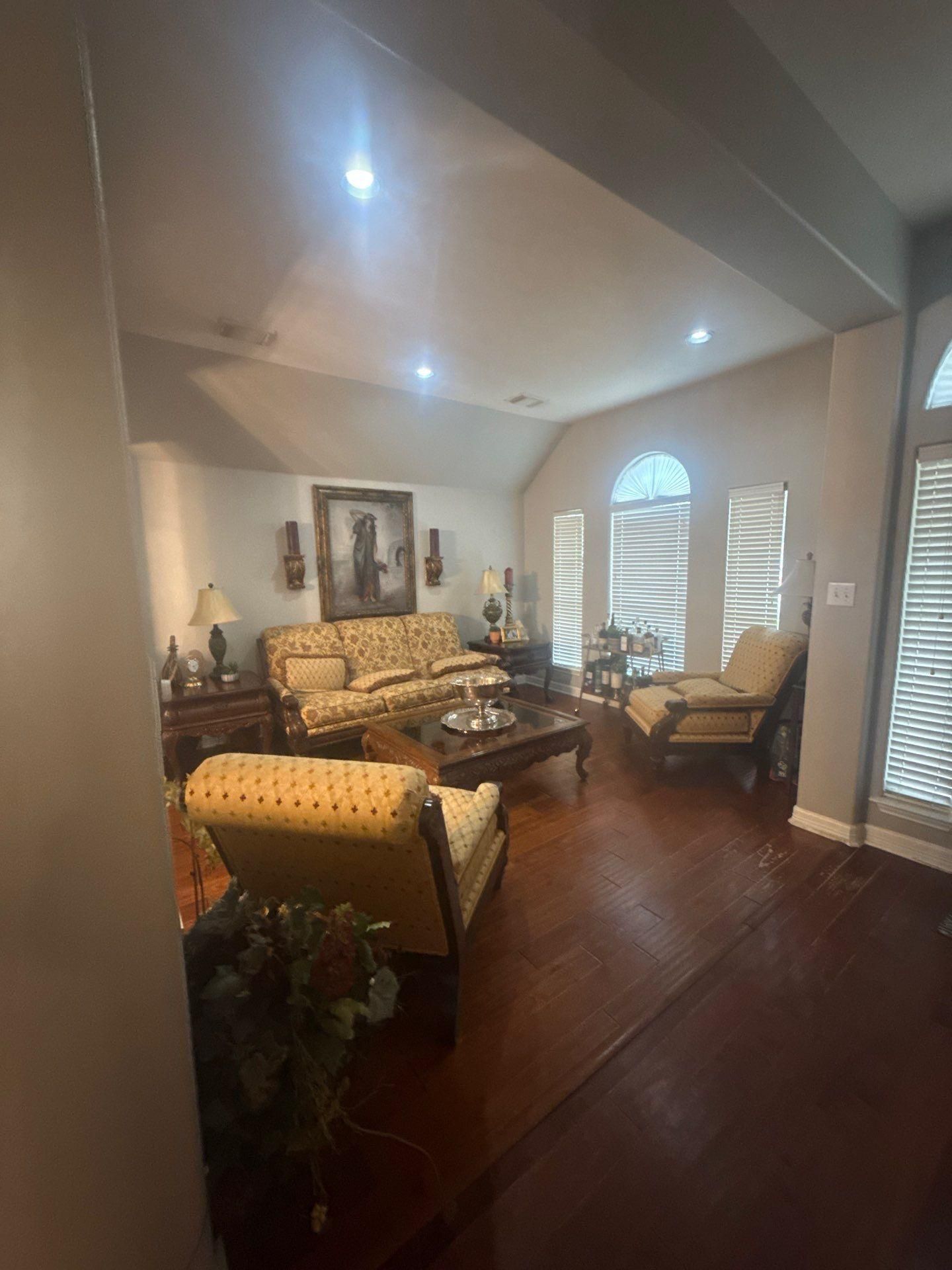 Living room with vaulted ceiling in a home on Laurel Bay Loop in Round Rock, TX prepared for ceiling painting by Hill Country Painting