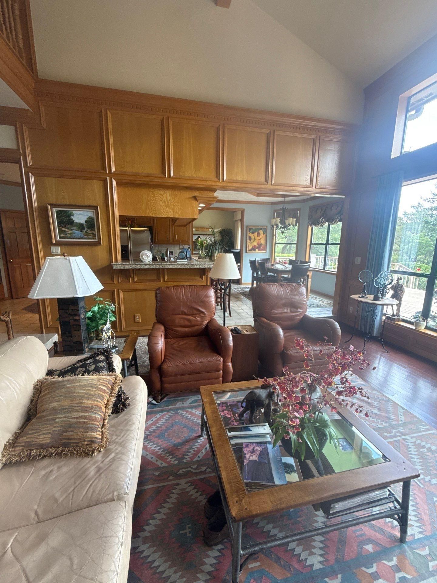 Great room with wood kitchen cabinetry in a home on Chapin Ln in Austin, TX prepared for cabinet refinishing by Hill Country Painting