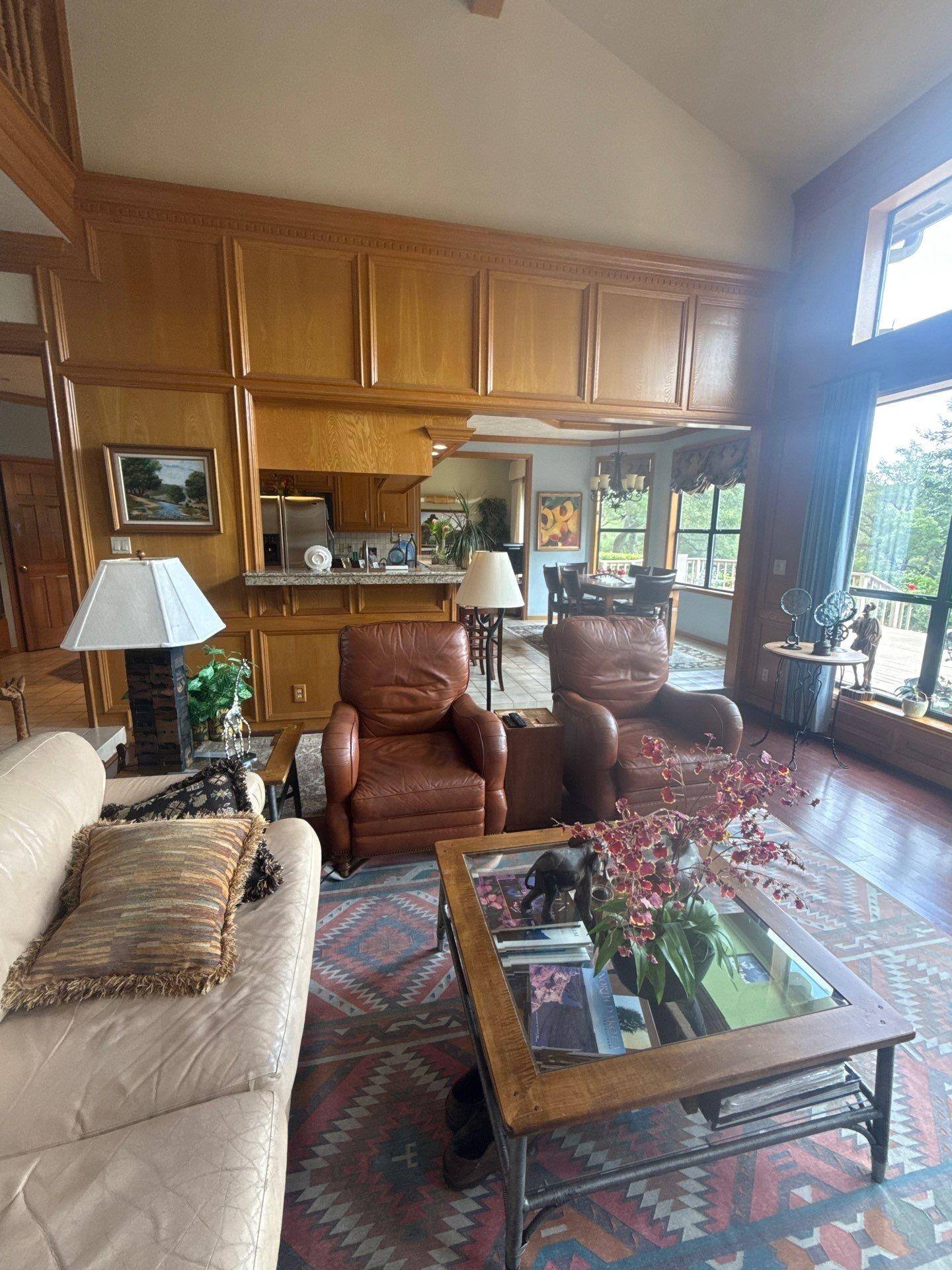Great room with wood kitchen cabinetry in a home on Chapin Ln in Austin, TX prepared for cabinet refinishing by Hill Country Painting