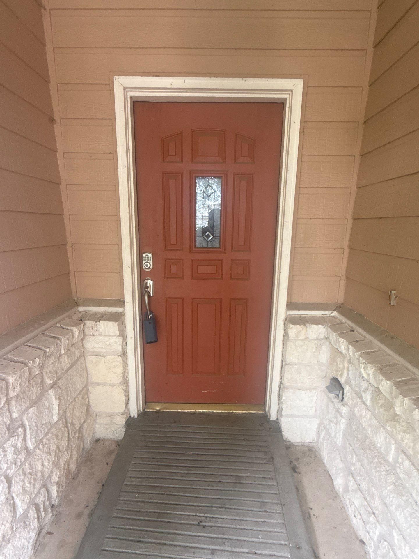 Entry door on a home on Cora Marie Dr in Pflugerville, TX prepared for painting by Hill Country Painting