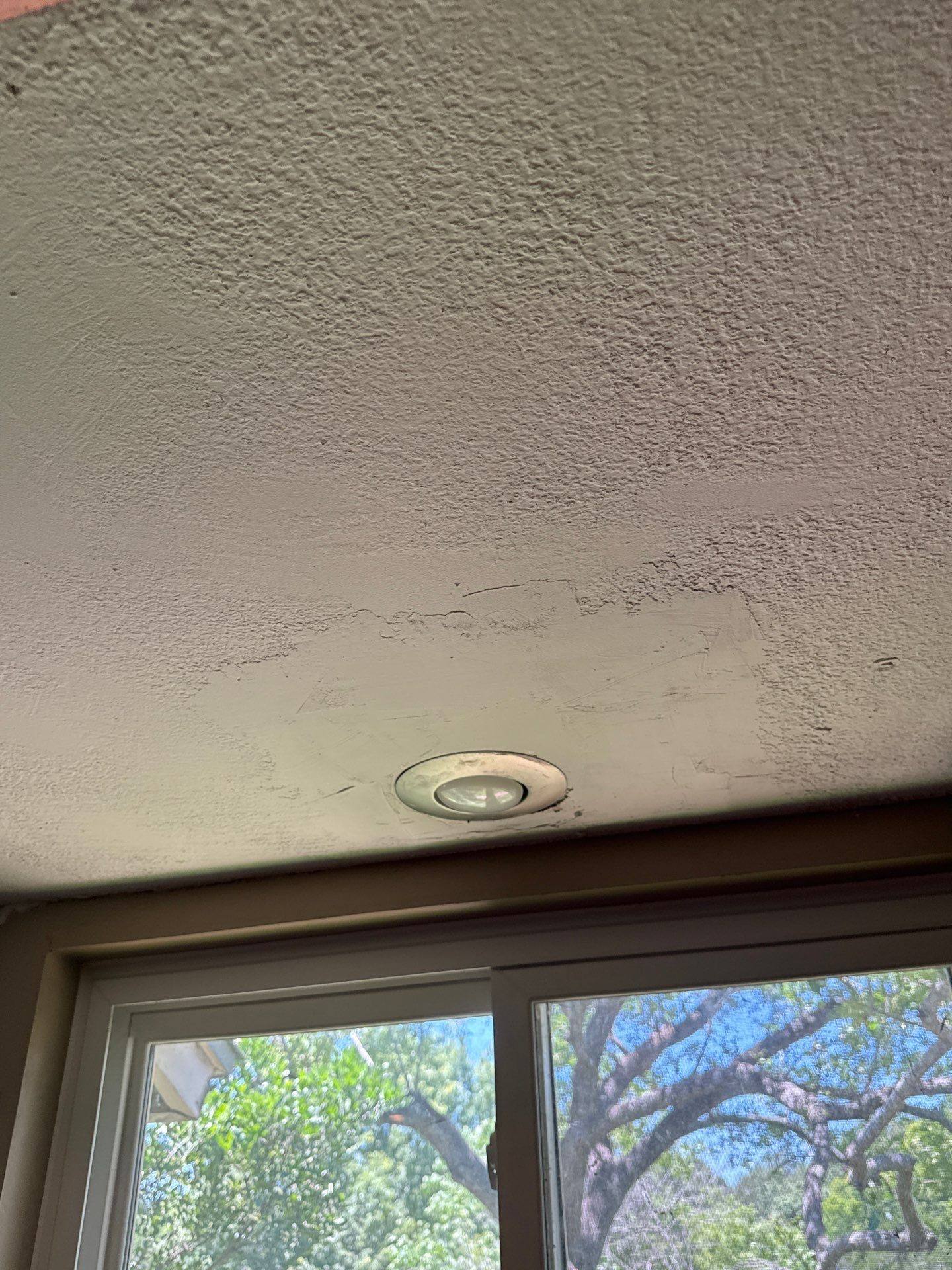 Ceiling texture crack near a window in a home on Granada Hills Dr in Austin, TX before re-texture and painting by Hill Country Painting