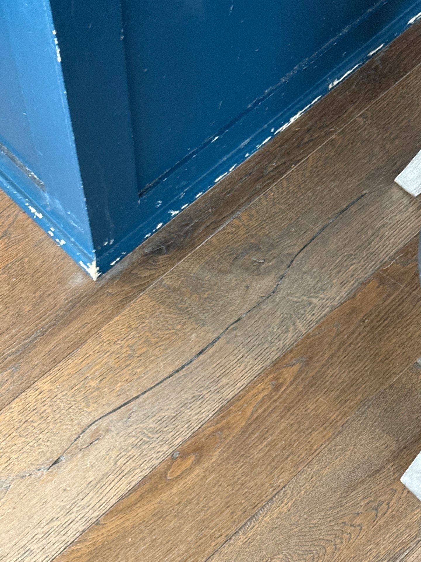 Hallway baseboard and door frame detail in a home on Townes Ct in Dripping Springs, TX prepared for painting by Hill Country Painting