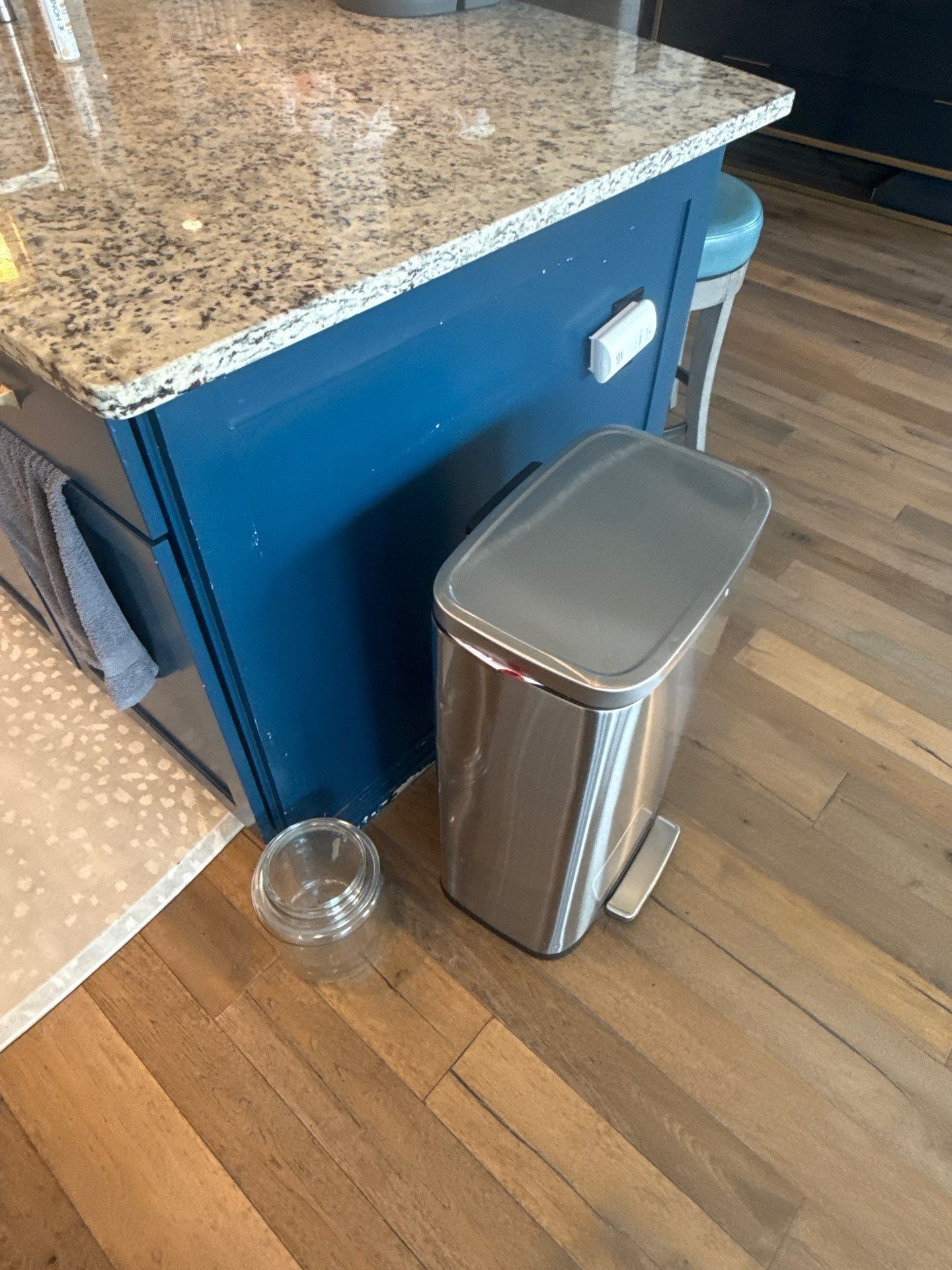 Kitchen island cabinet detail in a home on Townes Ct in Dripping Springs, TX before cabinet refinishing by Hill Country Painting