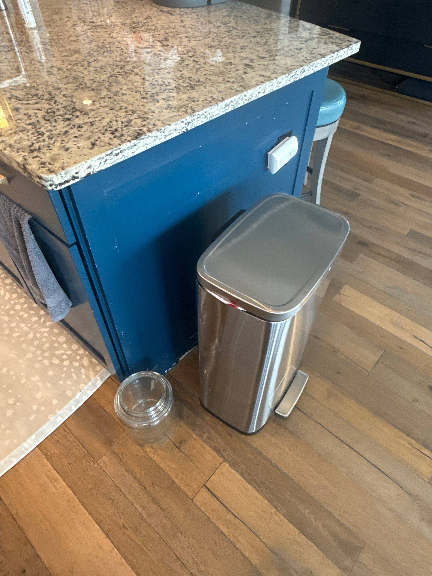 Kitchen island cabinet detail in a home on Townes Ct in Dripping Springs, TX before cabinet refinishing by Hill Country Painting