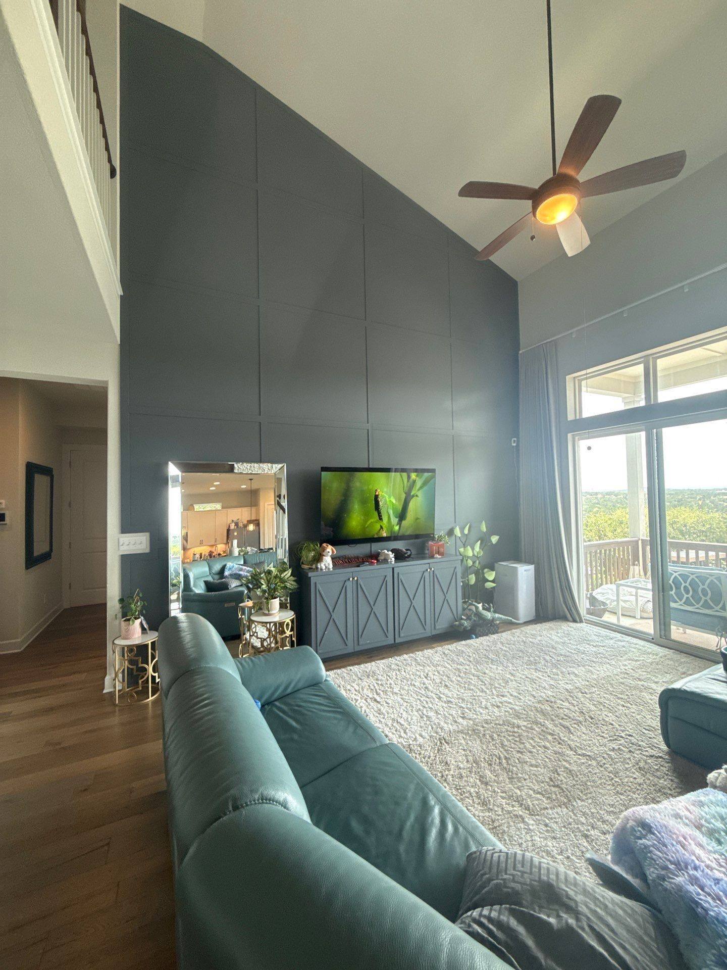 Living room with tall accent wall in a home on Townes Ct in Dripping Springs, TX prepared for painting by Hill Country Painting