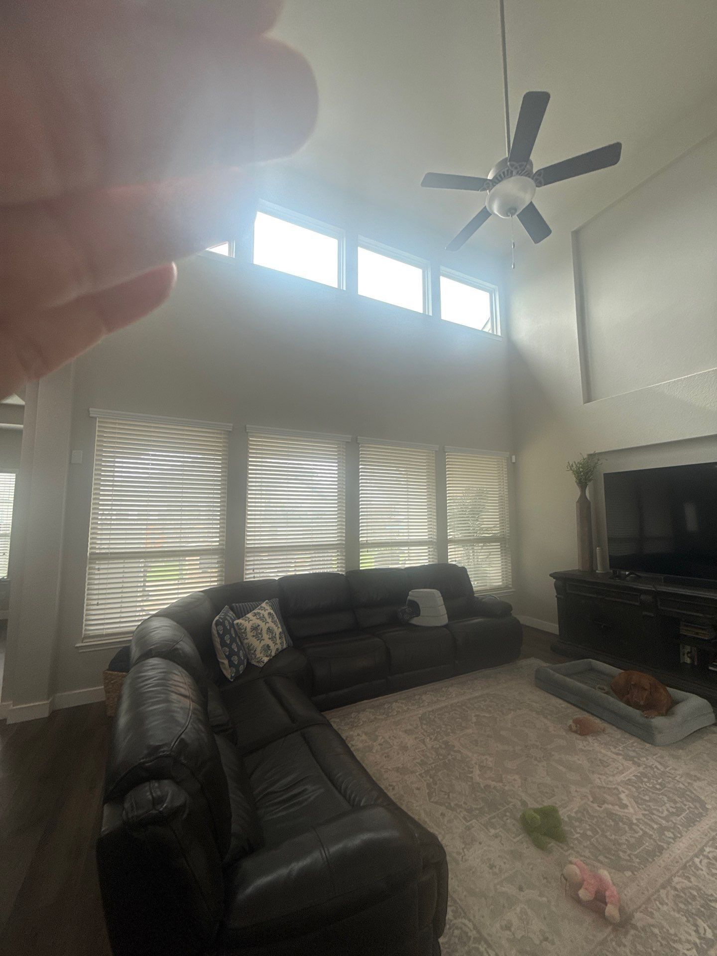 Living room with vaulted ceiling in a home on Kite Wing Ter in Pflugerville, TX prepared for painting by Hill Country Painting