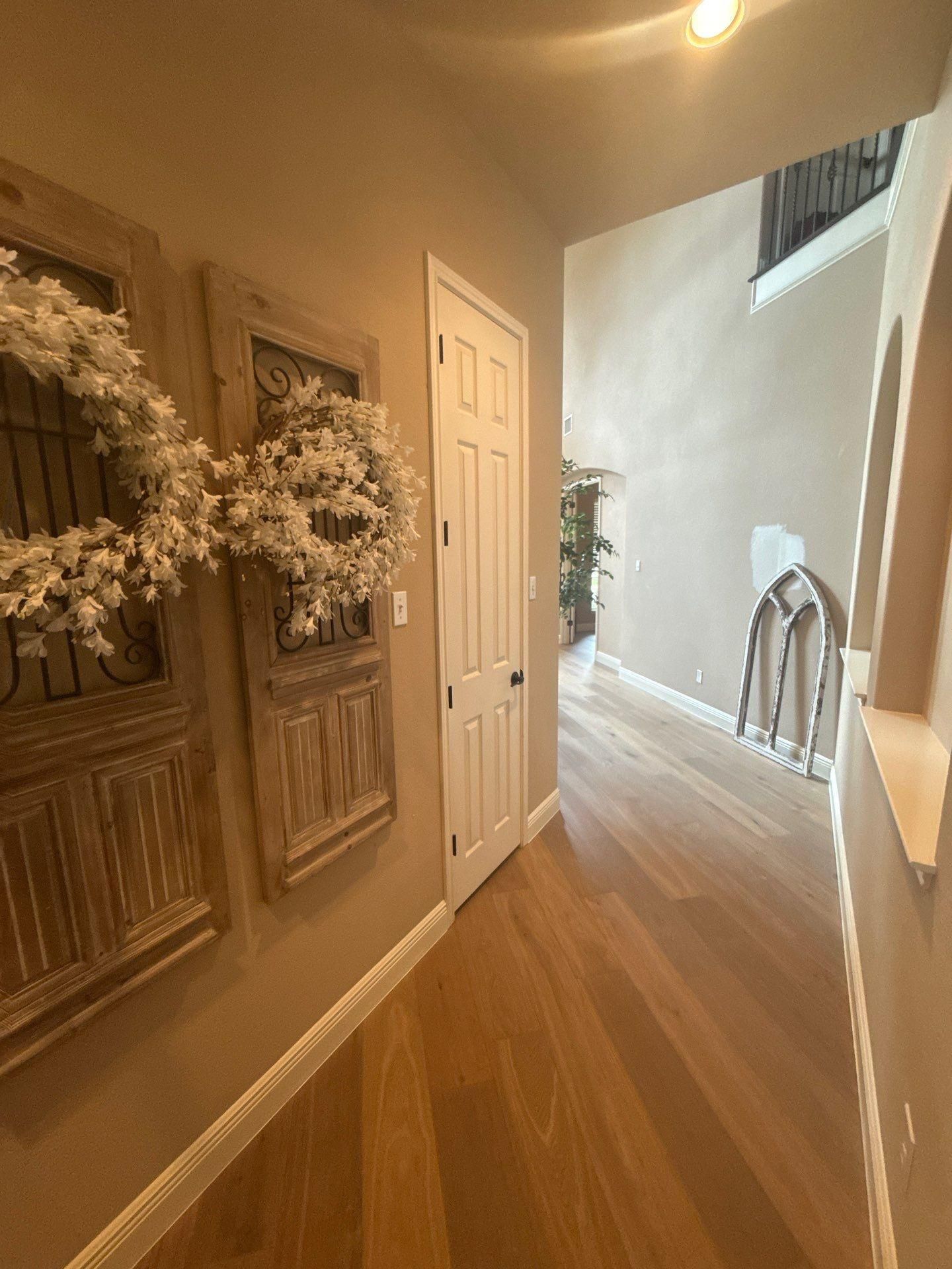 Hallway with vaulted ceiling in a home on Rhondstat Run in Cedar Park, TX prepared for painting by Hill Country Painting