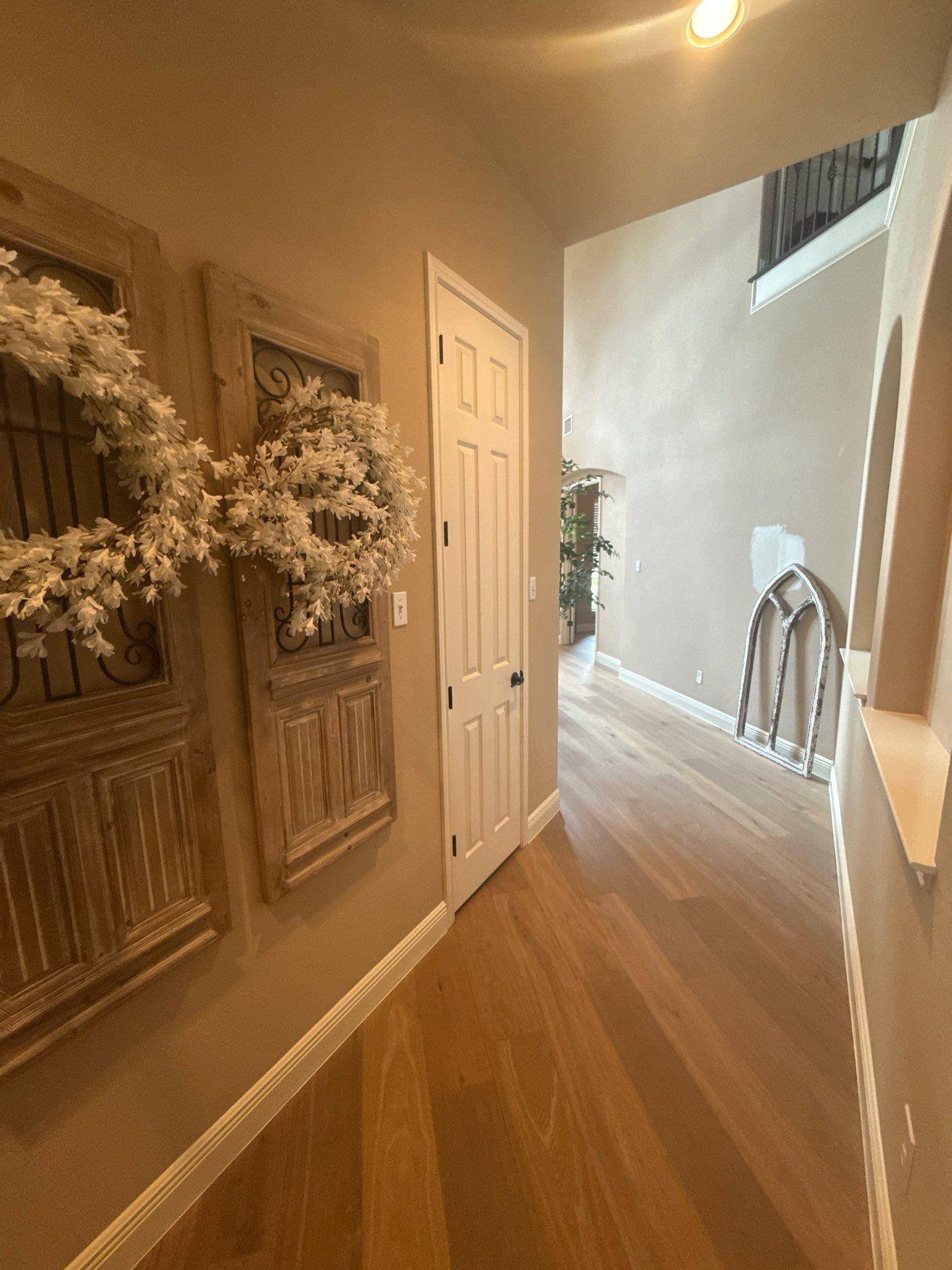 Hallway with vaulted ceiling in a home on Rhondstat Run in Cedar Park, TX prepared for painting by Hill Country Painting