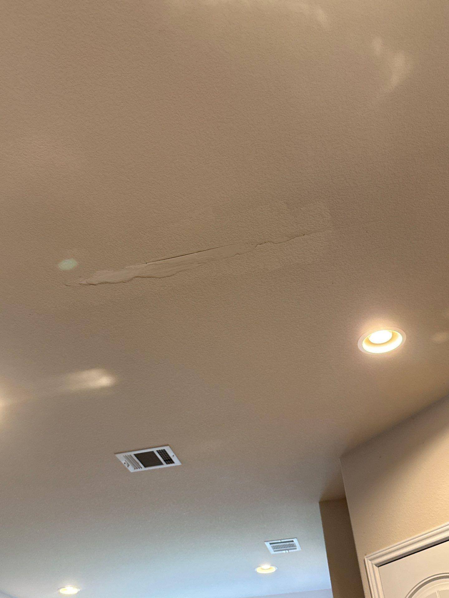 Kitchen ceiling crack repair detail in a home on Mossy Grove Ct in Cedar Park, TX prepared for painting by Hill Country Painting