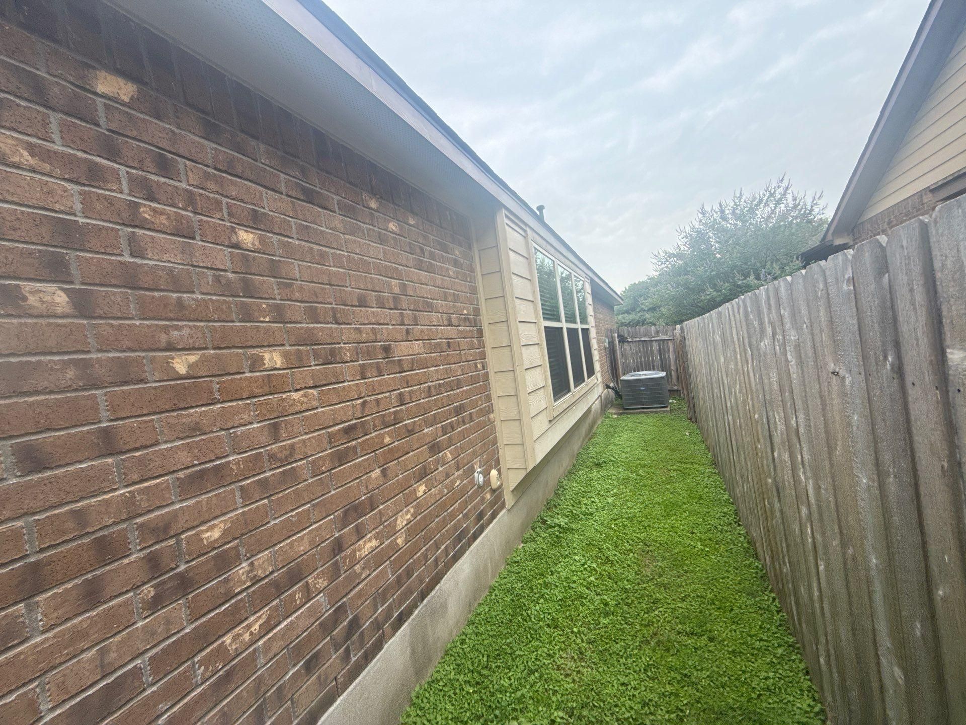 Left side of a home on Kingsland Way in Austin, TX prepared for painting by Hill Country Painting