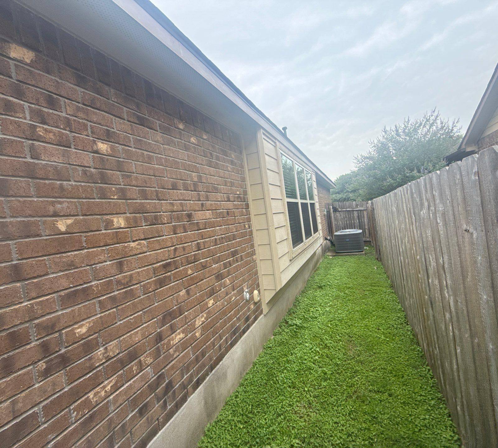 Left side of a home on Kingsland Way in Austin, TX prepared for painting by Hill Country Painting
