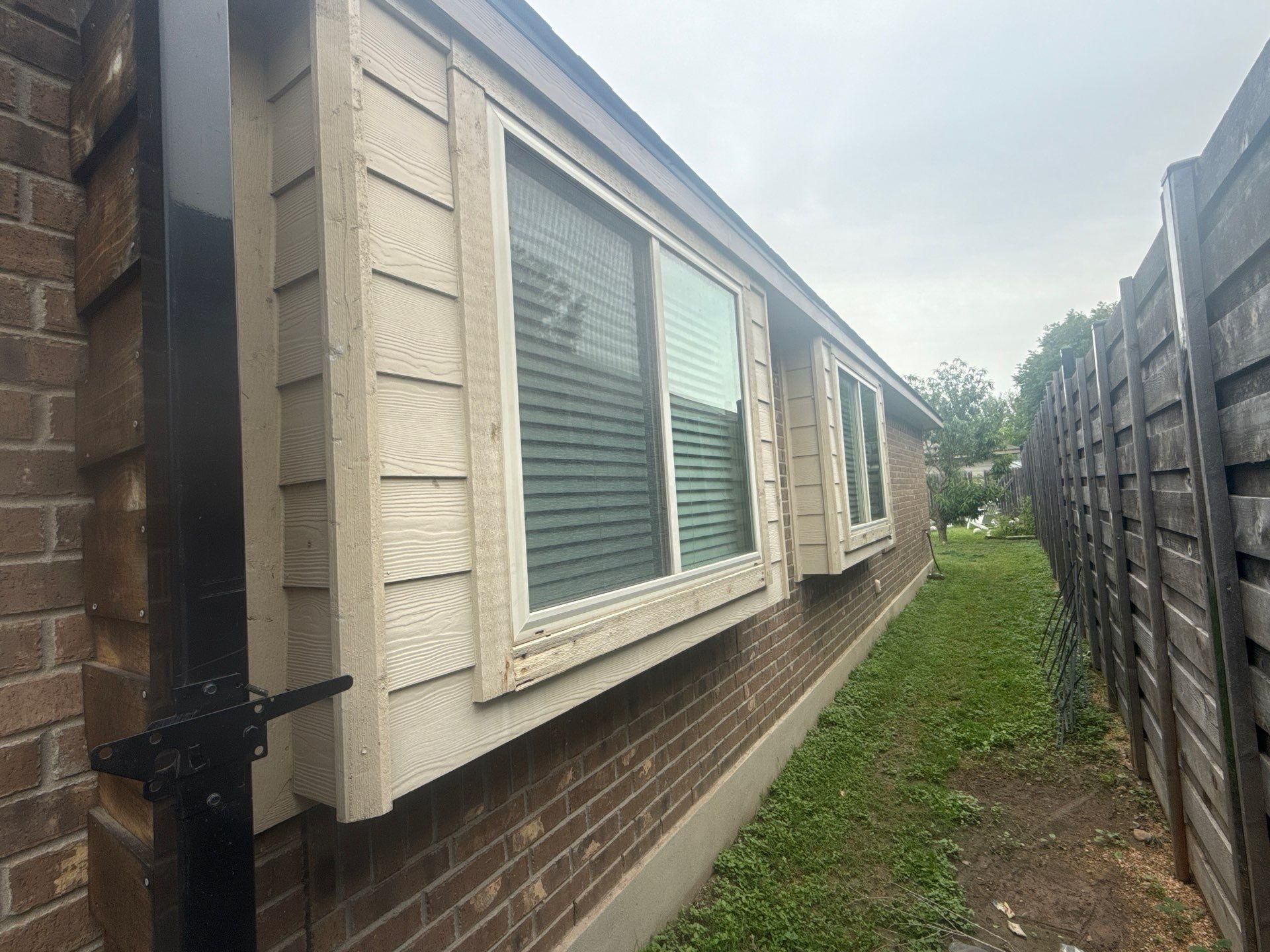 Right side of a home on Kingsland Way in Austin, TX prepared for painting by Hill Country Painting
