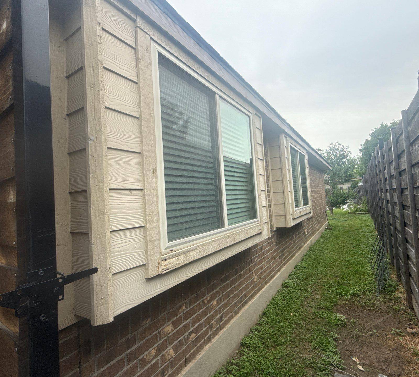 Right side of a home on Kingsland Way in Austin, TX prepared for painting by Hill Country Painting