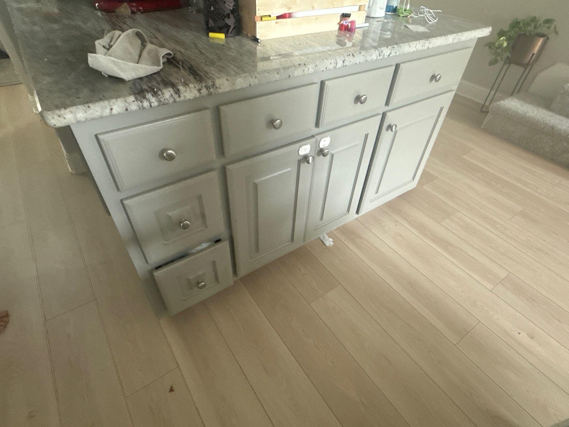 Kitchen island cabinet doors and drawers in a home on Tuberose Terrace in Austin, TX refinished by Hill Country Painting
