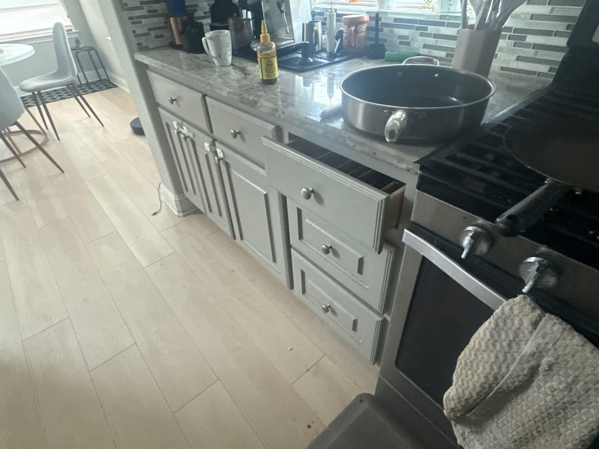 Kitchen cabinets near the range in a home on Tuberose Terrace in Austin, TX refinished by Hill Country Painting