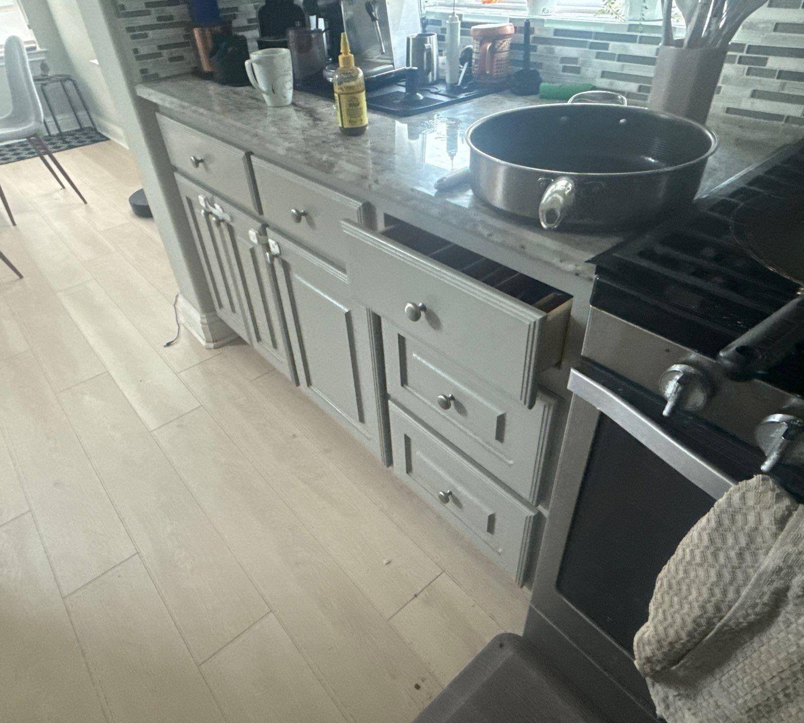 Kitchen cabinets near the range in a home on Tuberose Terrace in Austin, TX refinished by Hill Country Painting