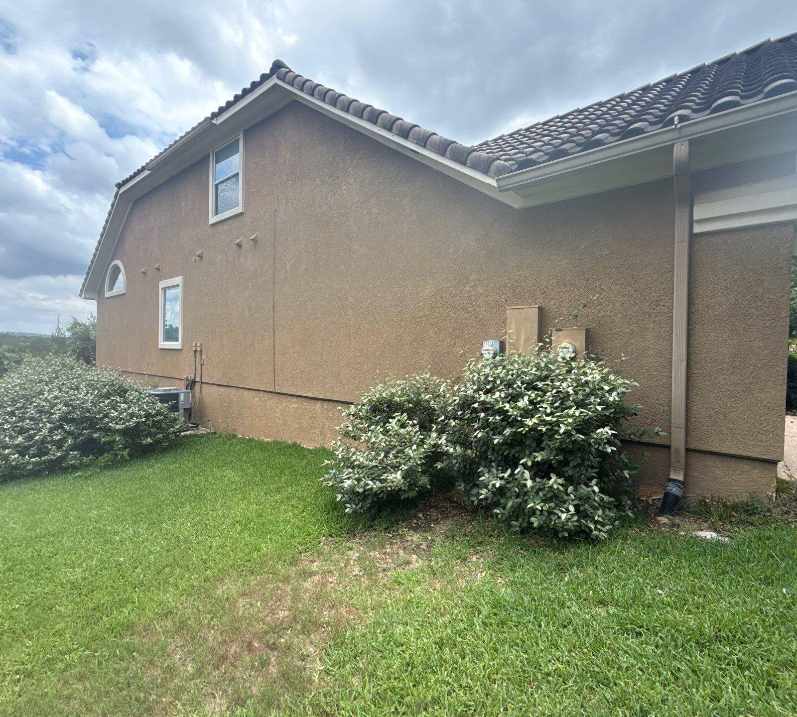 Left side of a home on Woodland Hills Trail in Austin, TX prepared for painting by Hill Country Painting