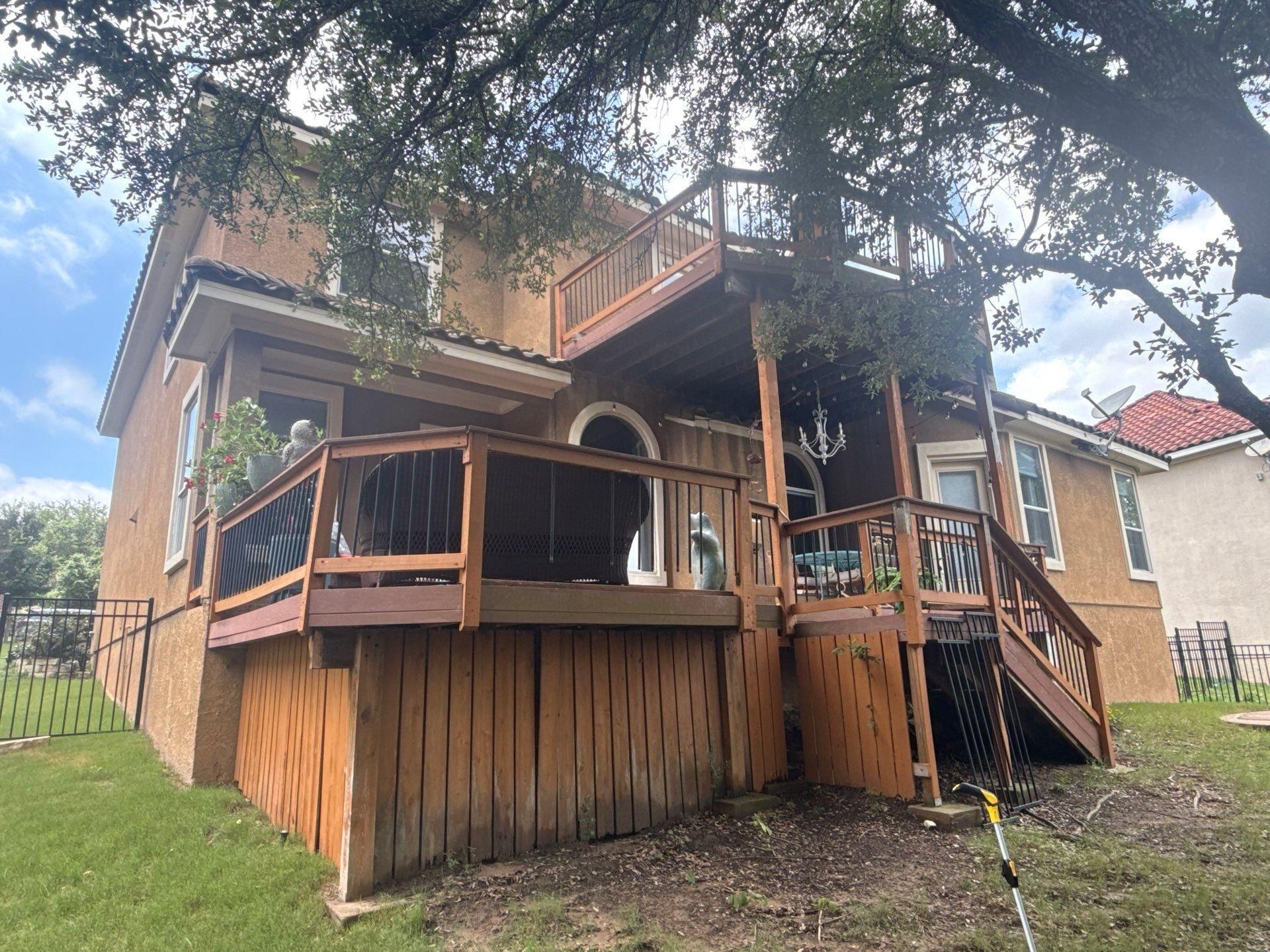 Back of a home on Woodland Hills Trail in Austin, TX prepared for painting by Hill Country Painting