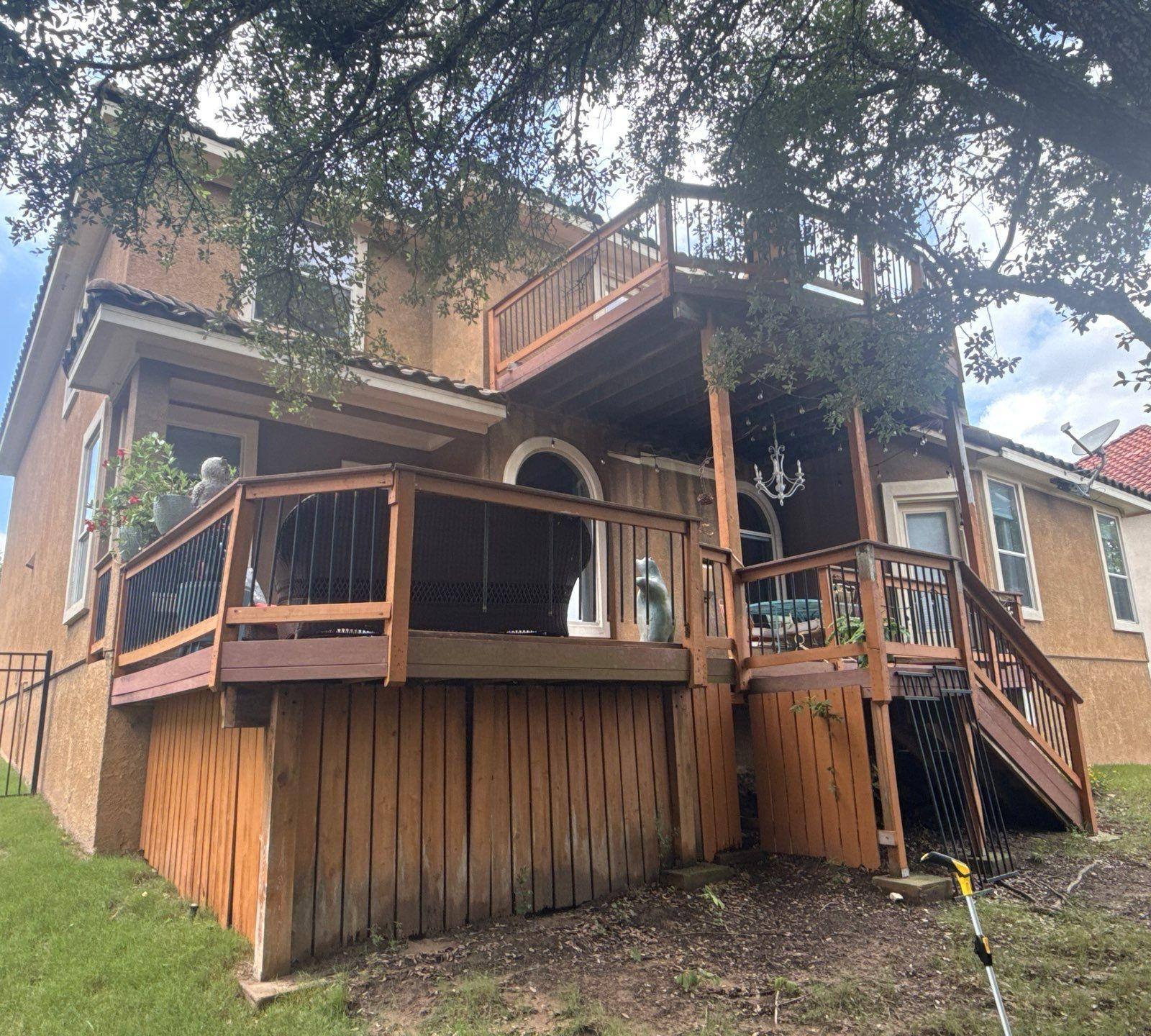Back of a home on Woodland Hills Trail in Austin, TX prepared for painting by Hill Country Painting