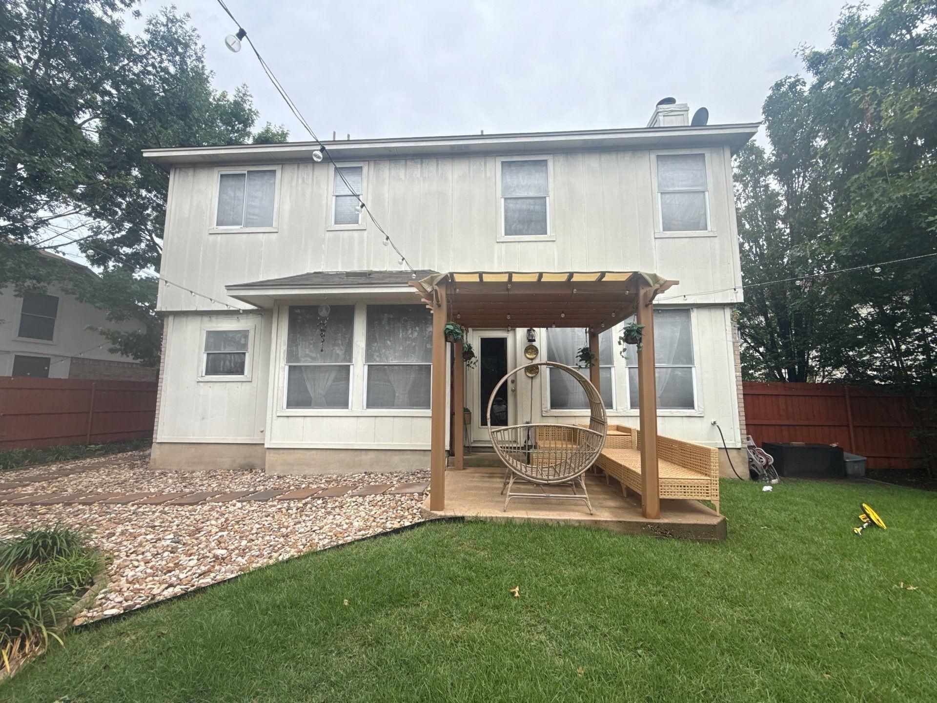 Back exterior and covered patio of a home on Portland Trail in Austin, TX prepared for a painting estimate by Hill Country Painting
