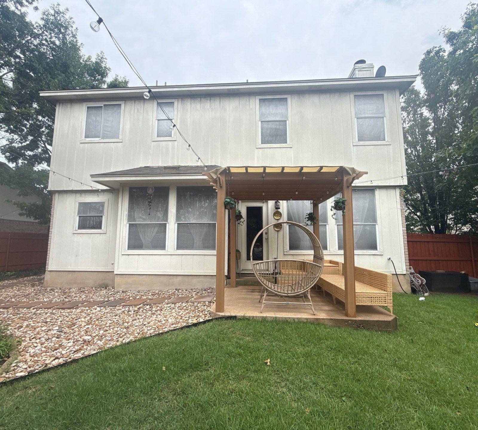 Back exterior and covered patio of a home on Portland Trail in Austin, TX prepared for a painting estimate by Hill Country Painting