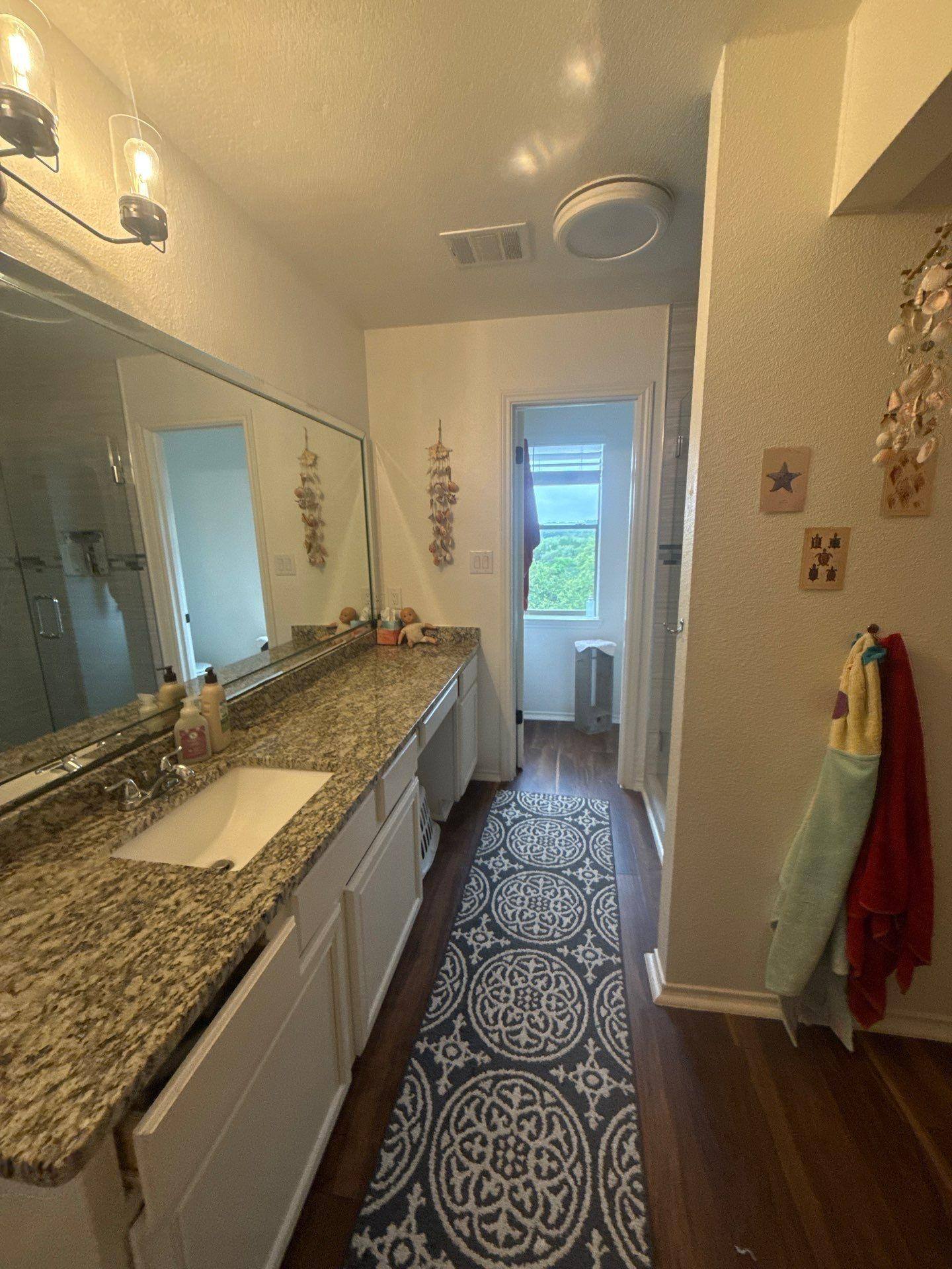 Bathroom of a home on Granada Hills Dr in Austin, TX prepared for painting by Hill Country Painting