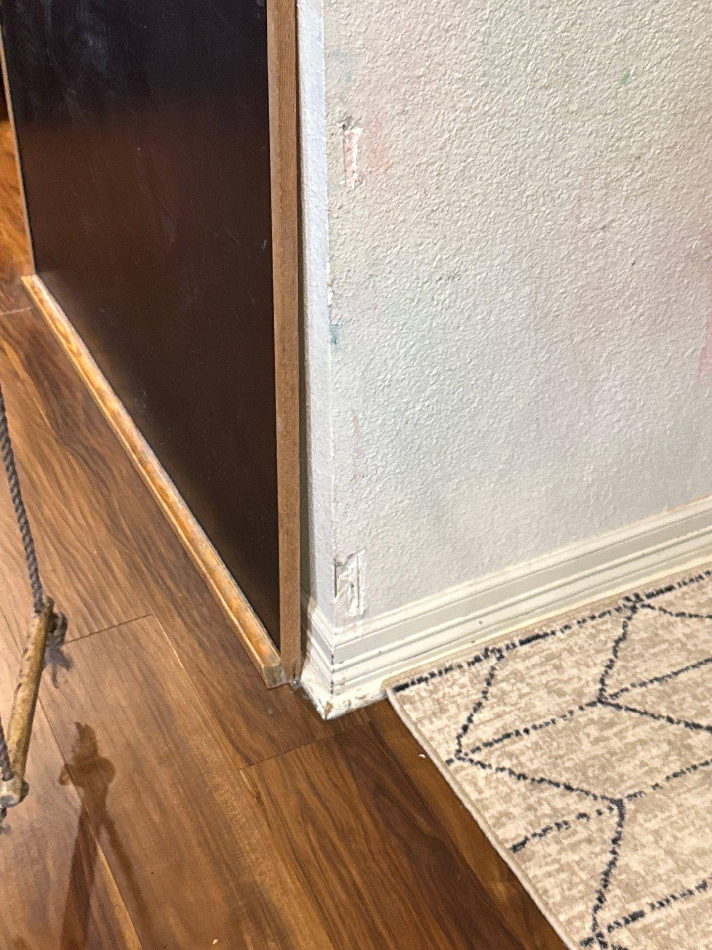 Baseboard and trim detail in a home on Granada Hills Dr in Austin, TX prepared for painting by Hill Country Painting