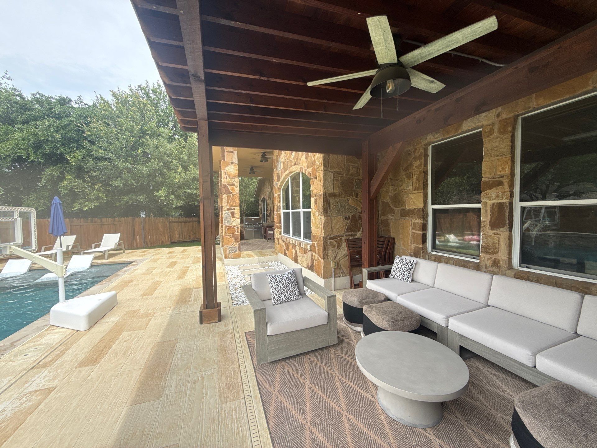 Covered back patio and pool area at a home on Avery Woods Ln in Cedar Park, TX prepared for a painting estimate by Hill Country Painting