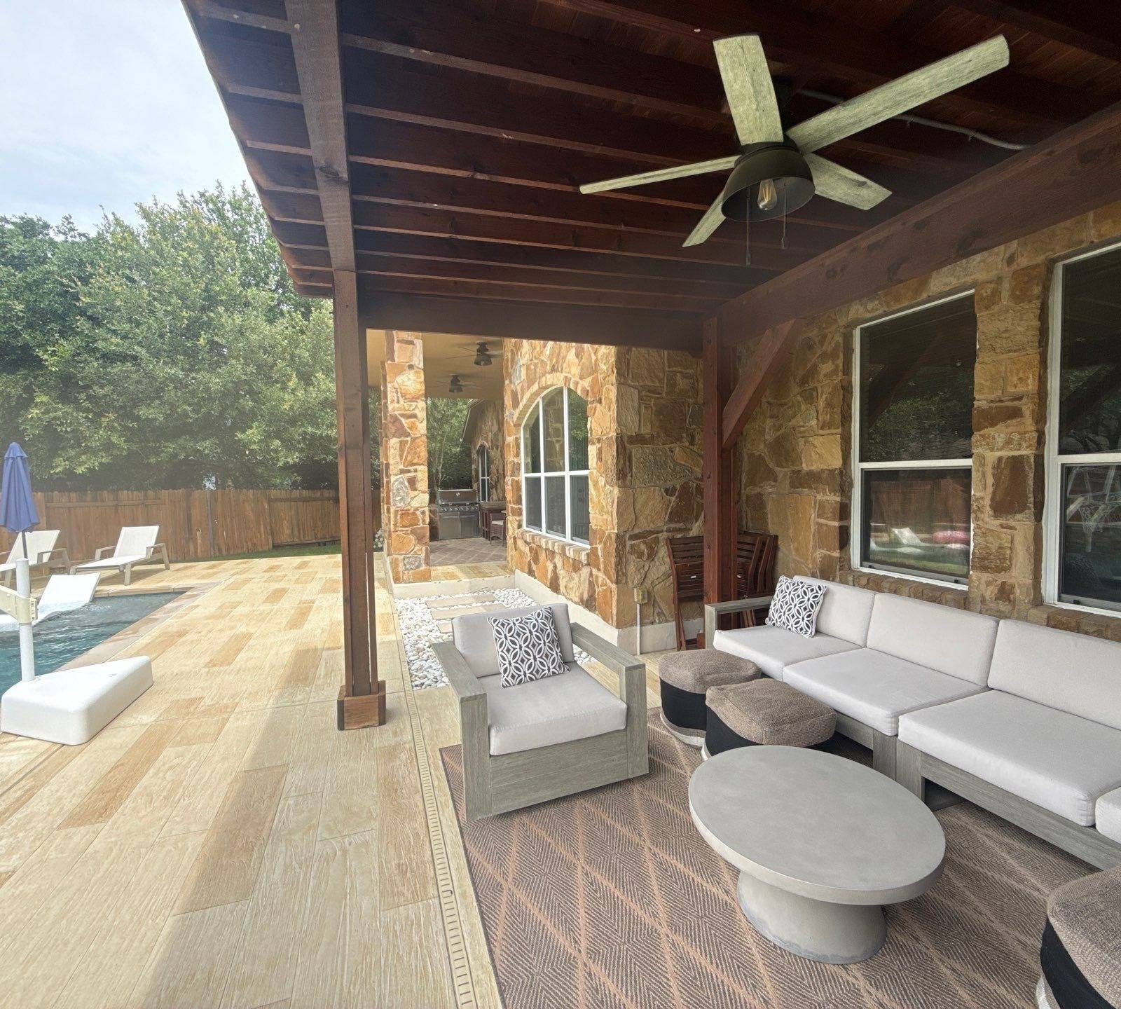 Covered back patio and pool area at a home on Avery Woods Ln in Cedar Park, TX prepared for a painting estimate by Hill Country Painting