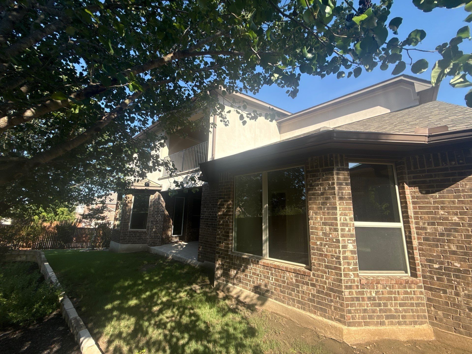 Back exterior elevation at a home on Borho Ranch St in Leander, TX prepared for a painting estimate by Hill Country Painting