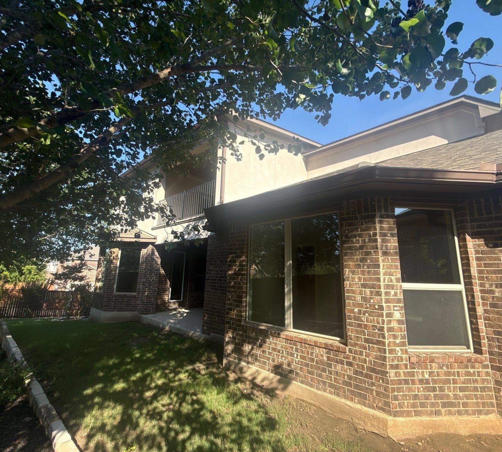 Back exterior elevation at a home on Borho Ranch St in Leander, TX prepared for a painting estimate by Hill Country Painting