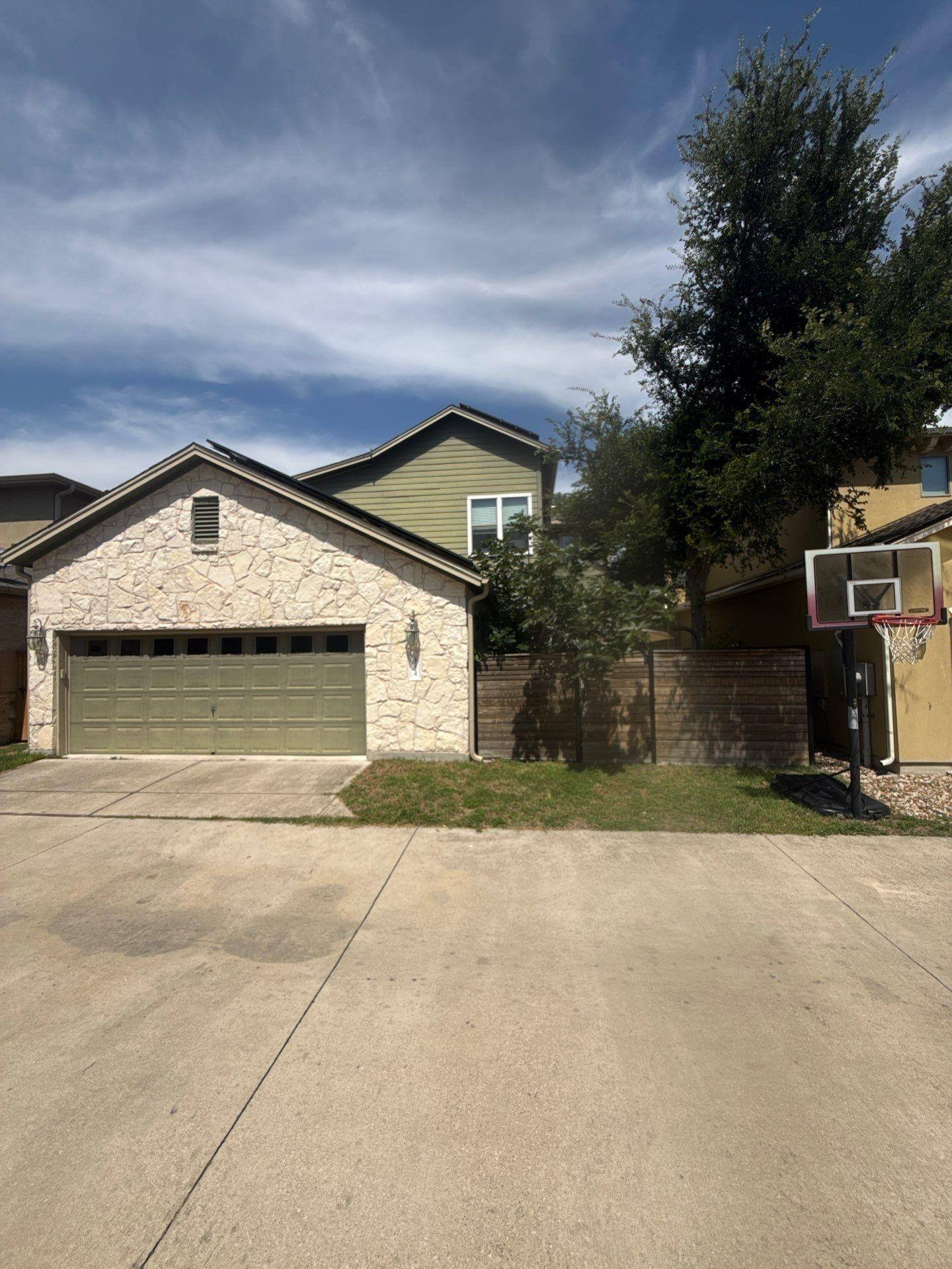 Front garage and entry area of a home on Gochman St in Austin, TX prepared for an exterior painting estimate by Hill Country Painting