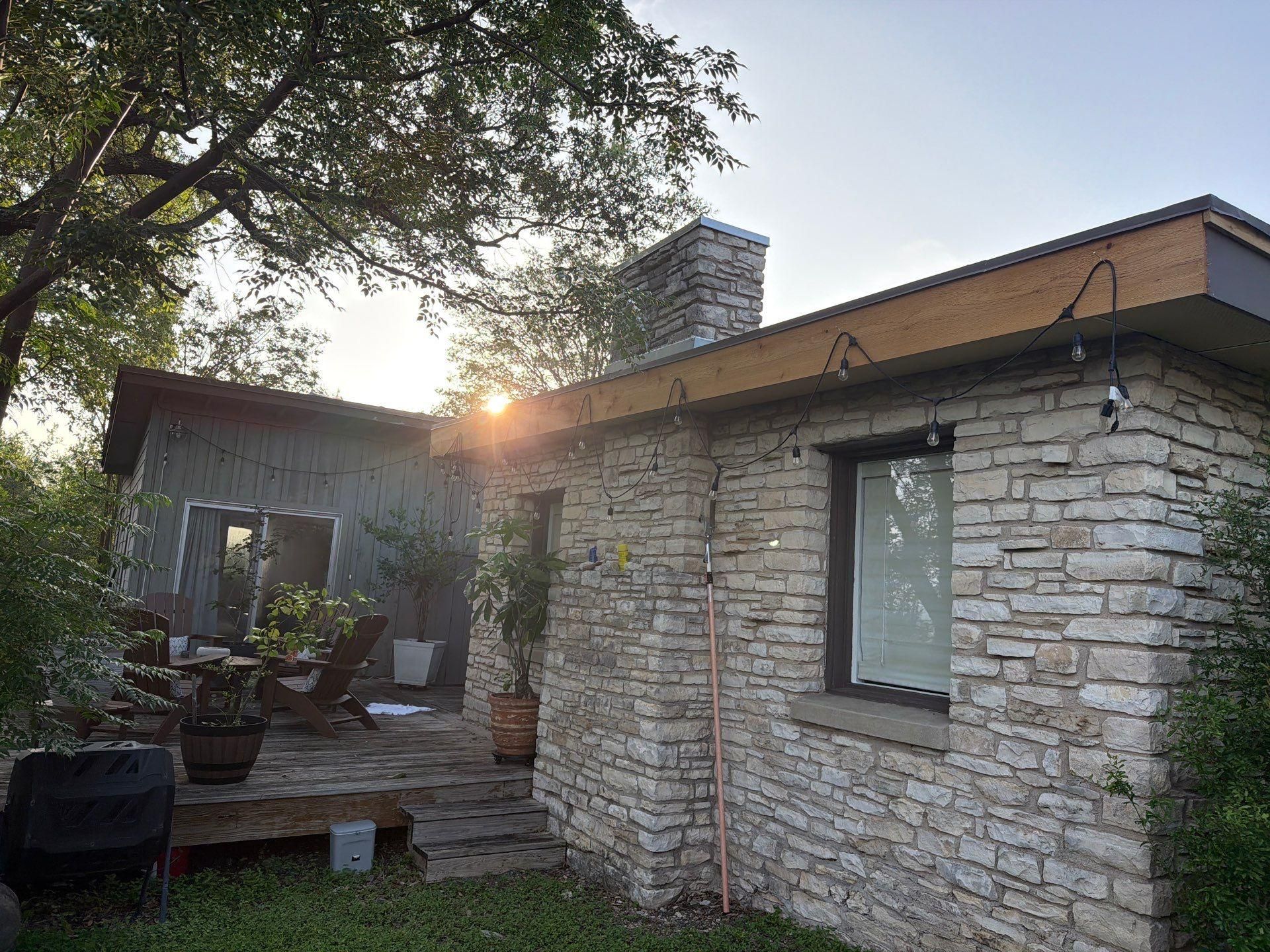 Back deck and patio area of a home on St Stephens Dr in Austin, TX during an exterior painting project by Hill Country Painting
