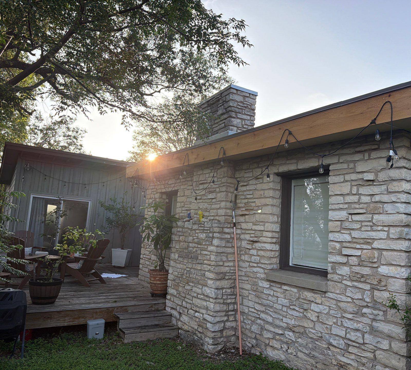 Back deck and patio area of a home on St Stephens Dr in Austin, TX during an exterior painting project by Hill Country Painting