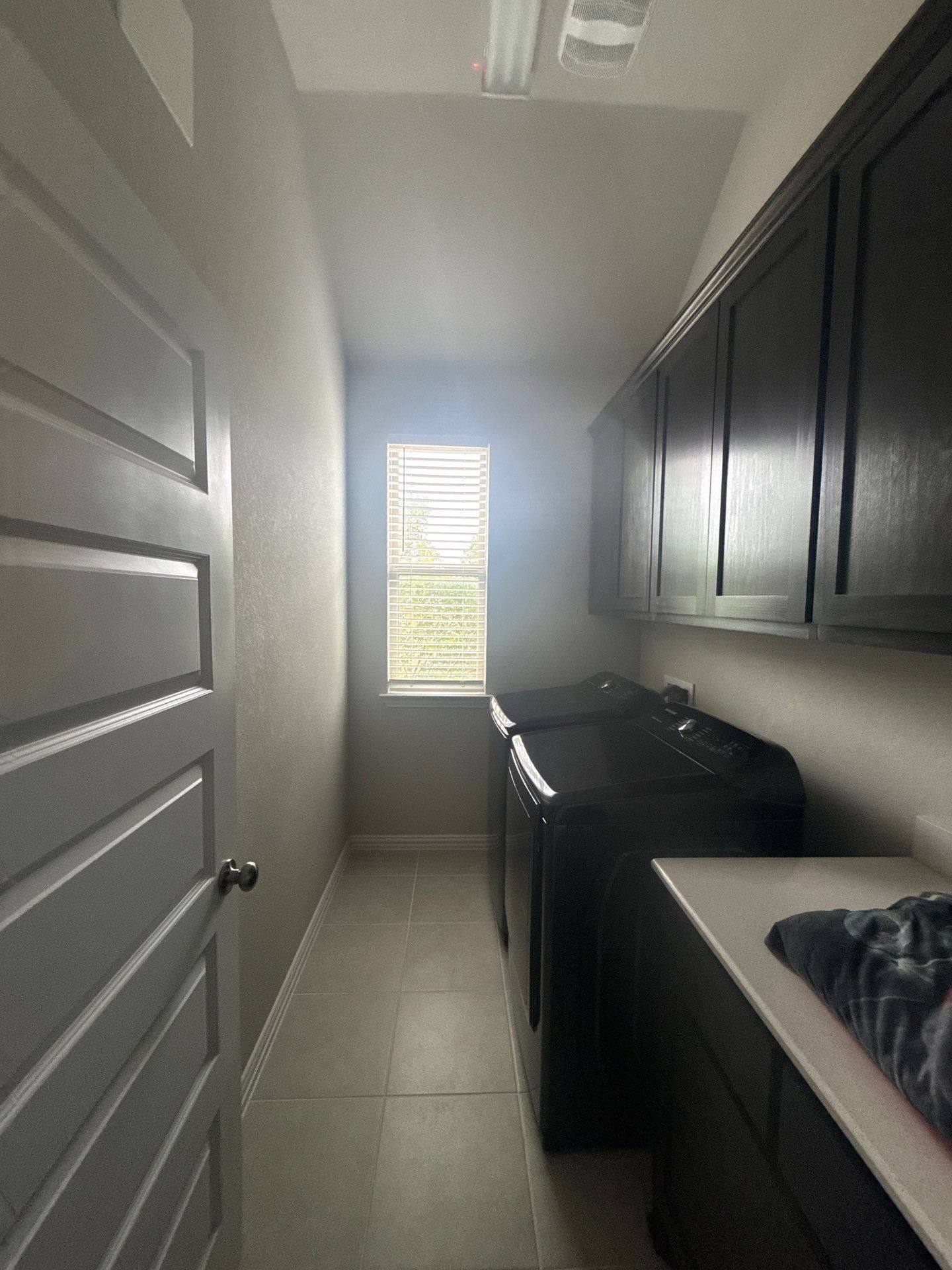 Laundry room of a home on Twisted Root Dr in Manchaca, TX prepared for an interior painting estimate by Hill Country Painting