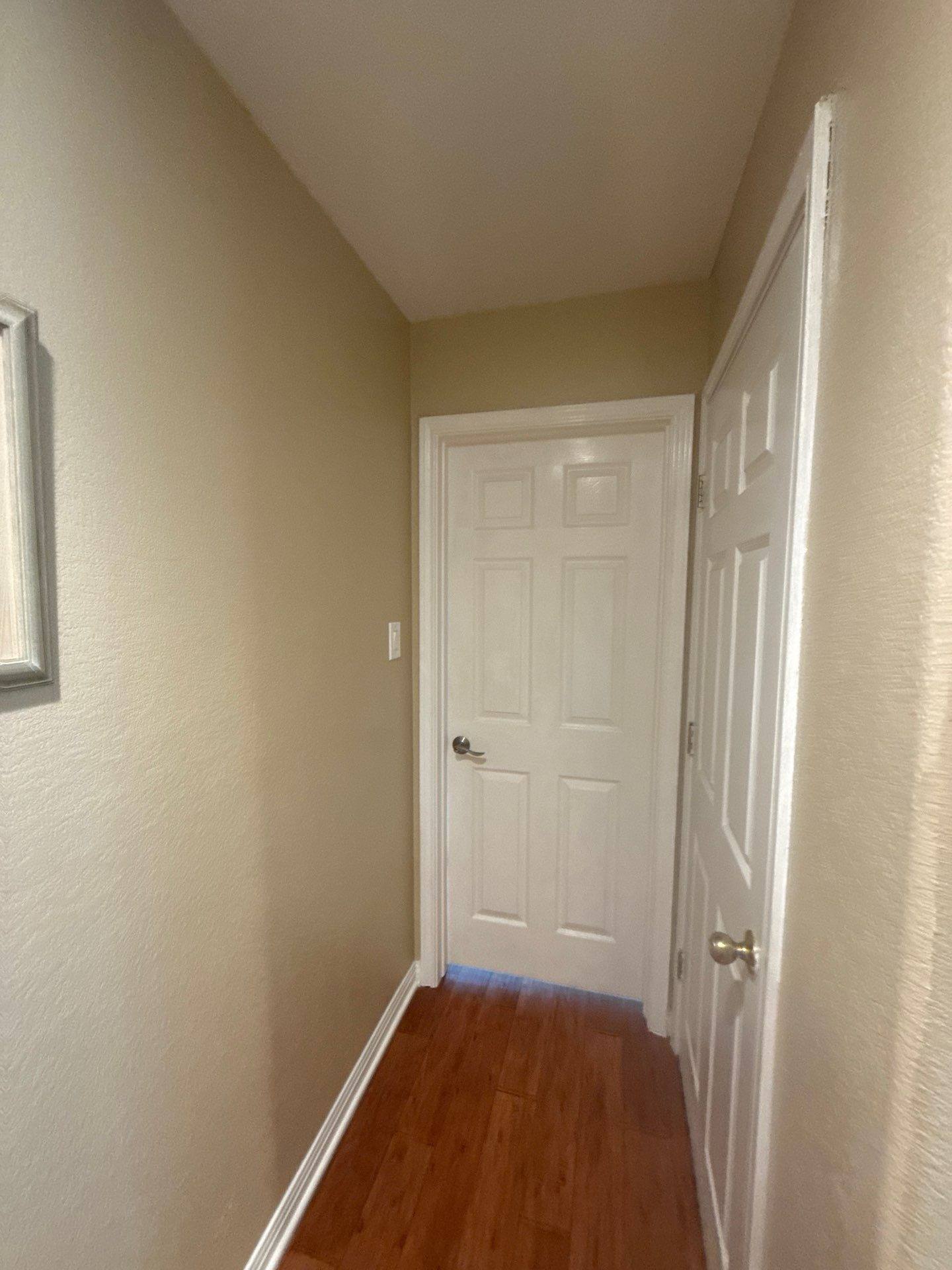 Downstairs hallway of a home on Springlake Dr in Dripping Springs, TX prepared for an interior painting estimate by Hill Country Painting