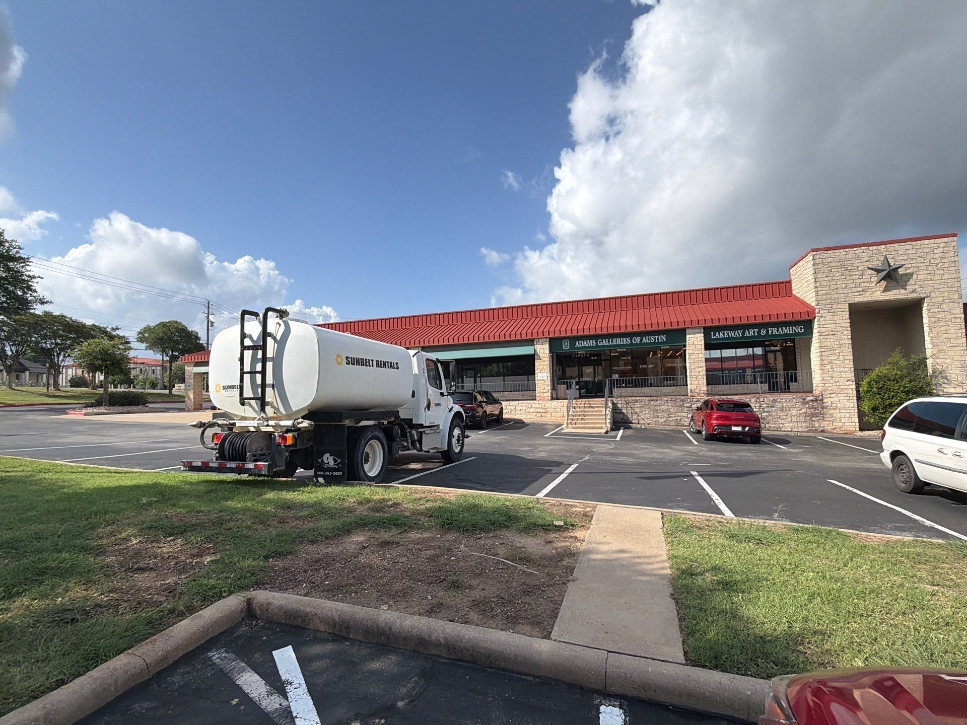 Storefront facade of a retail center on Ranch Rd 620 S in Lakeway, TX prepared for an exterior painting estimate by Hill Country Painting